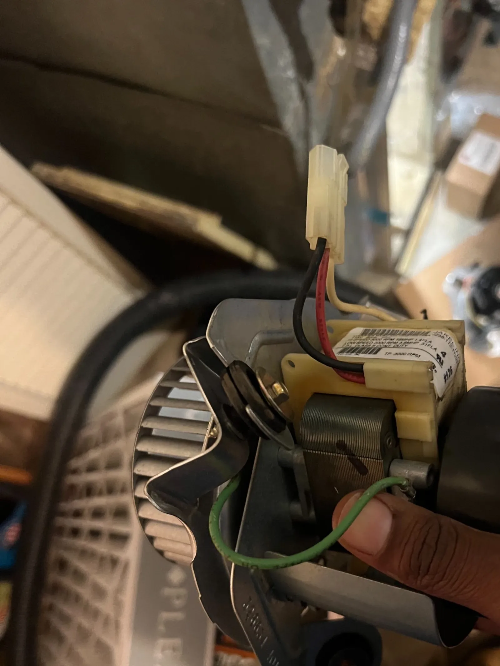 AC Cooling Repair in Atlanta Brookhaven 30319 by The Air Company of GA.  Electric motor with wires and metallic parts in a cluttered workshop setting.