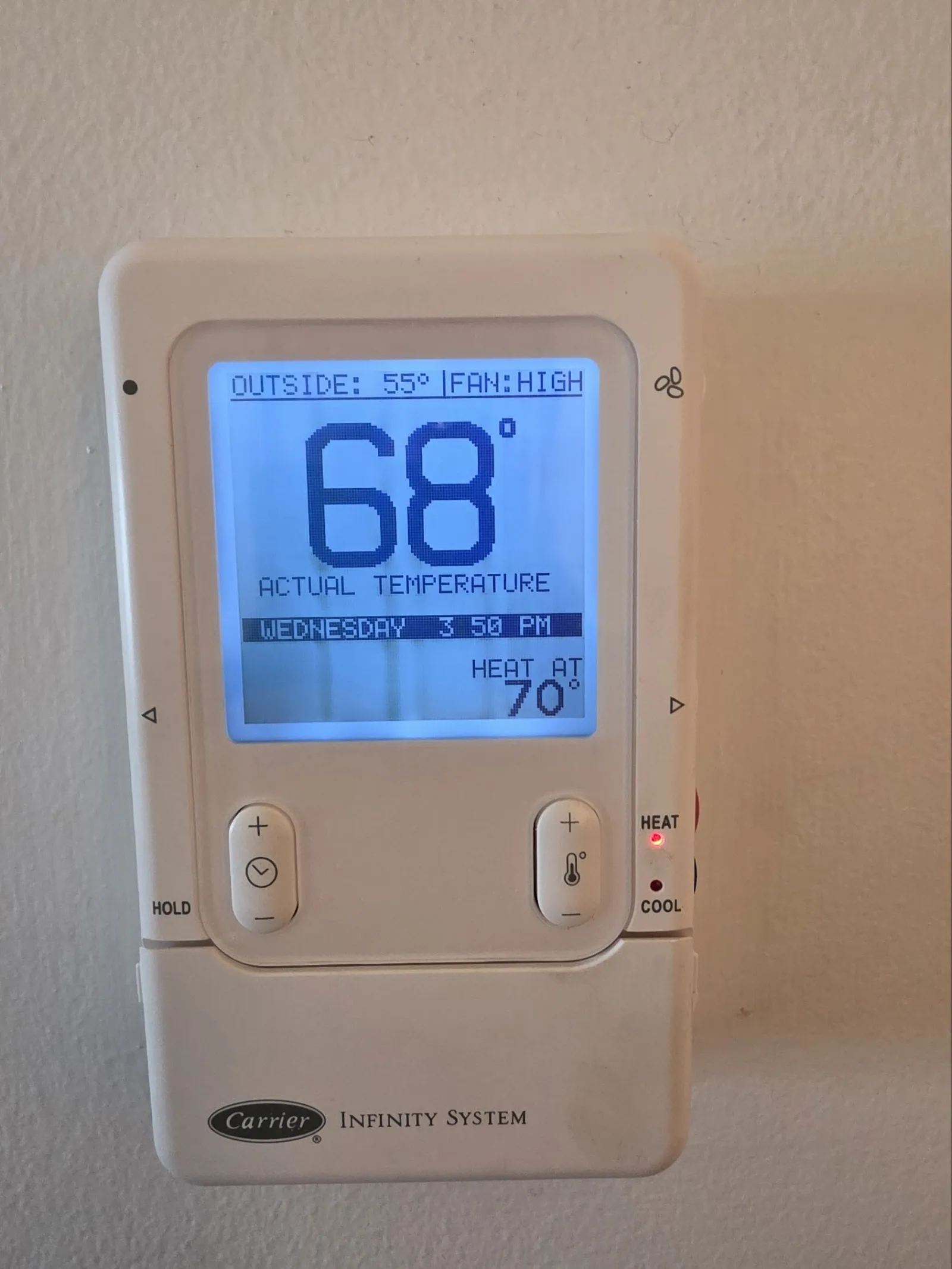 HVAC Thermostat Repair in Atlanta 30327 by The Air Company.  Carrier Infinity System thermostat showing 68 degrees inside temperature with heat mode and fan on high.