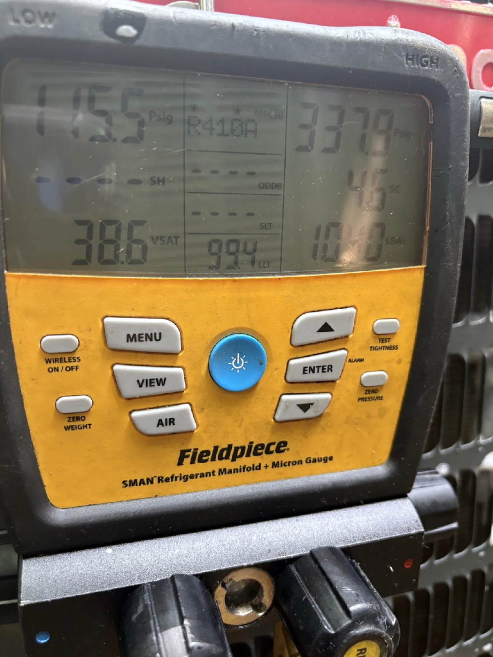 Fieldpiece 5MAN refrigerant manifold and micron gauge showing pressure readings and control buttons.