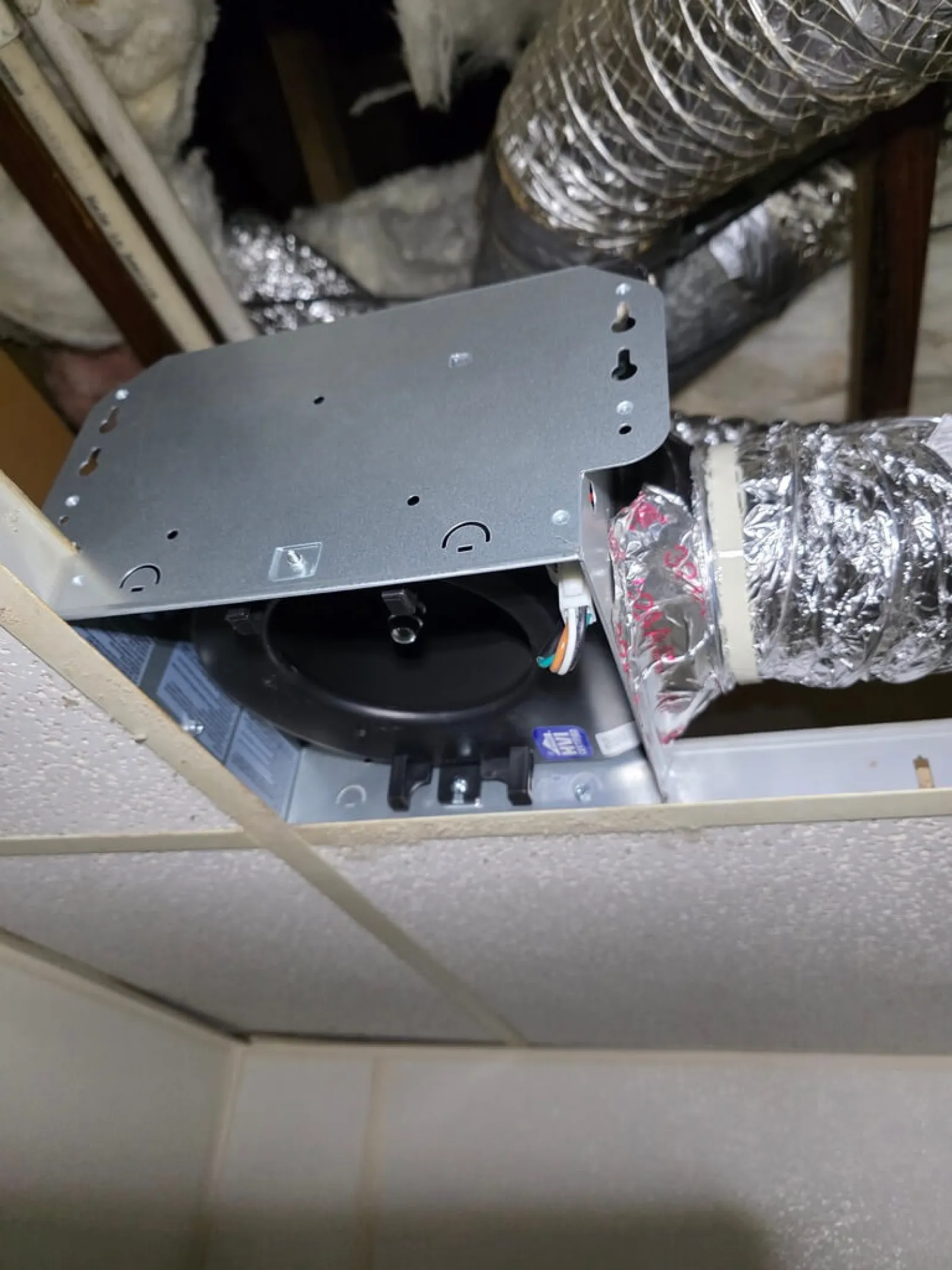 Ceiling exhaust fan installation with metal housing and insulated ductwork repair in Doraville 30340 by The Air Company of GA