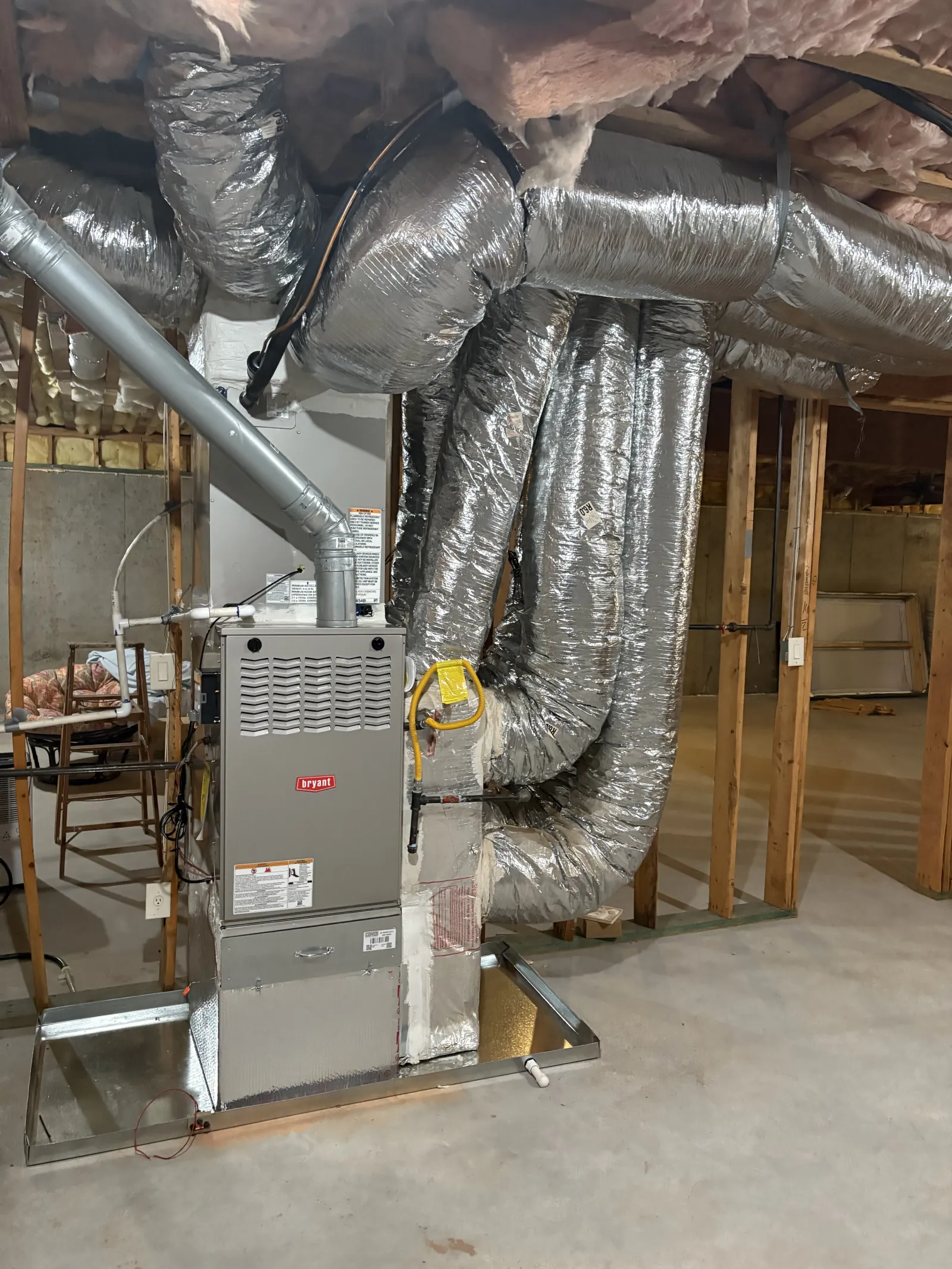 Bryant HVAC furnace system with insulated ductwork installed in an unfinished basement