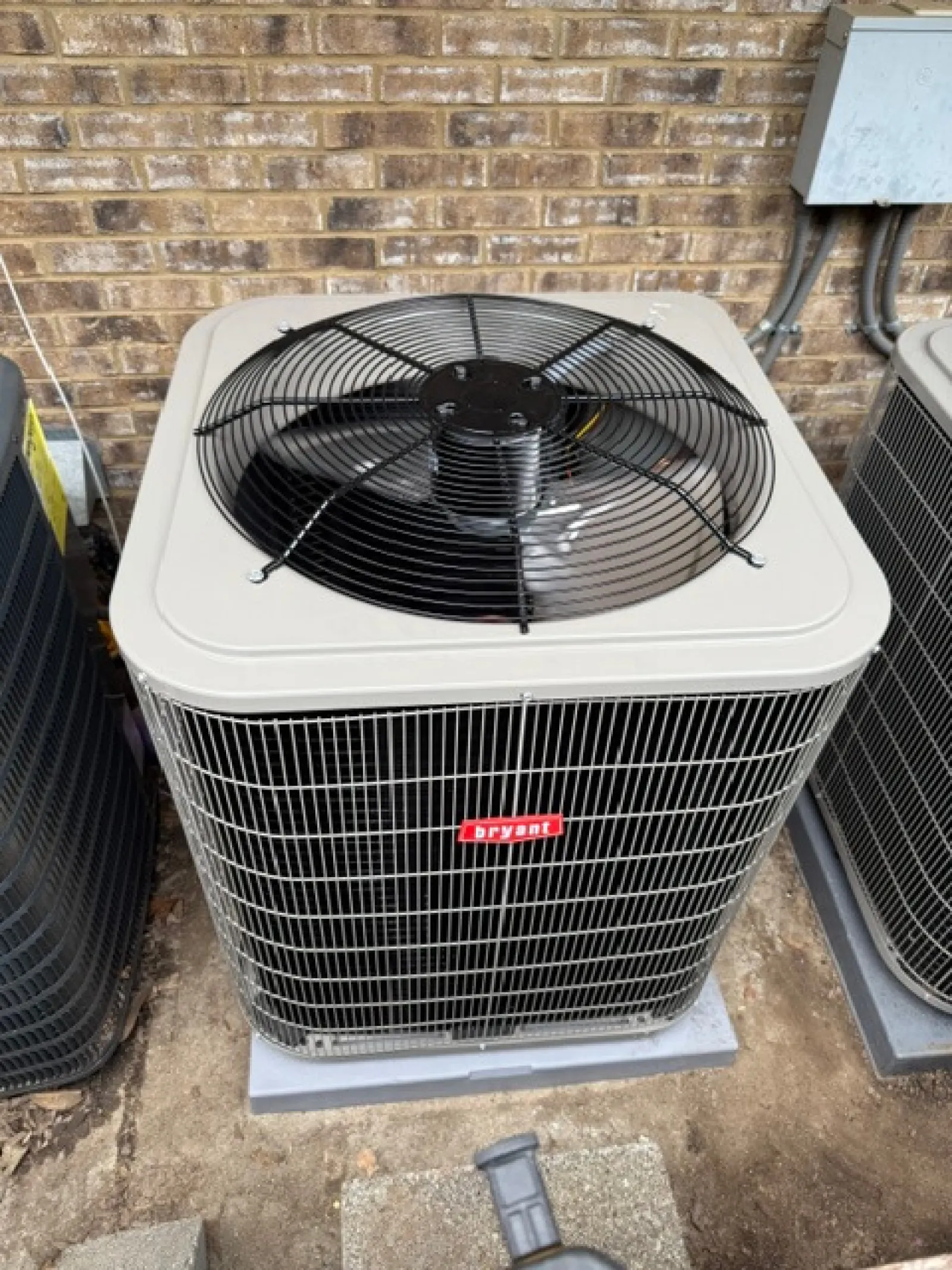 Bryant brand outdoor air conditioning unit with protective fan grill