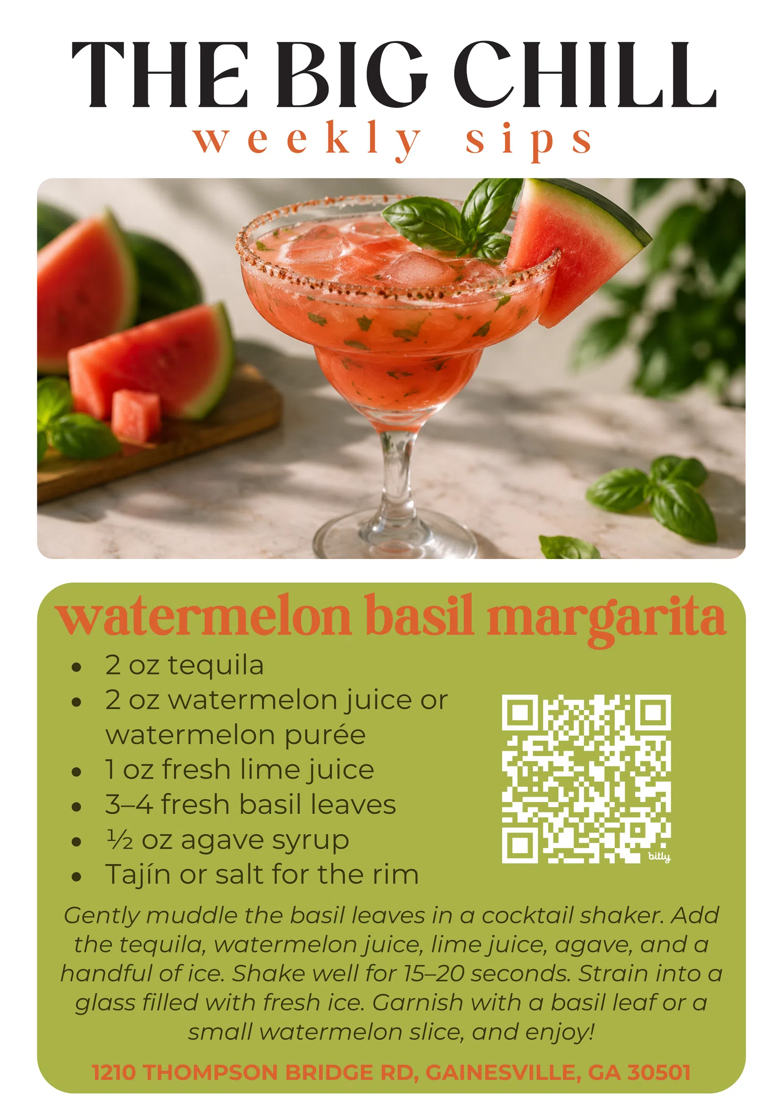 Watermelon basil margarita in a glass garnished with watermelon slice and basil on marble surface.