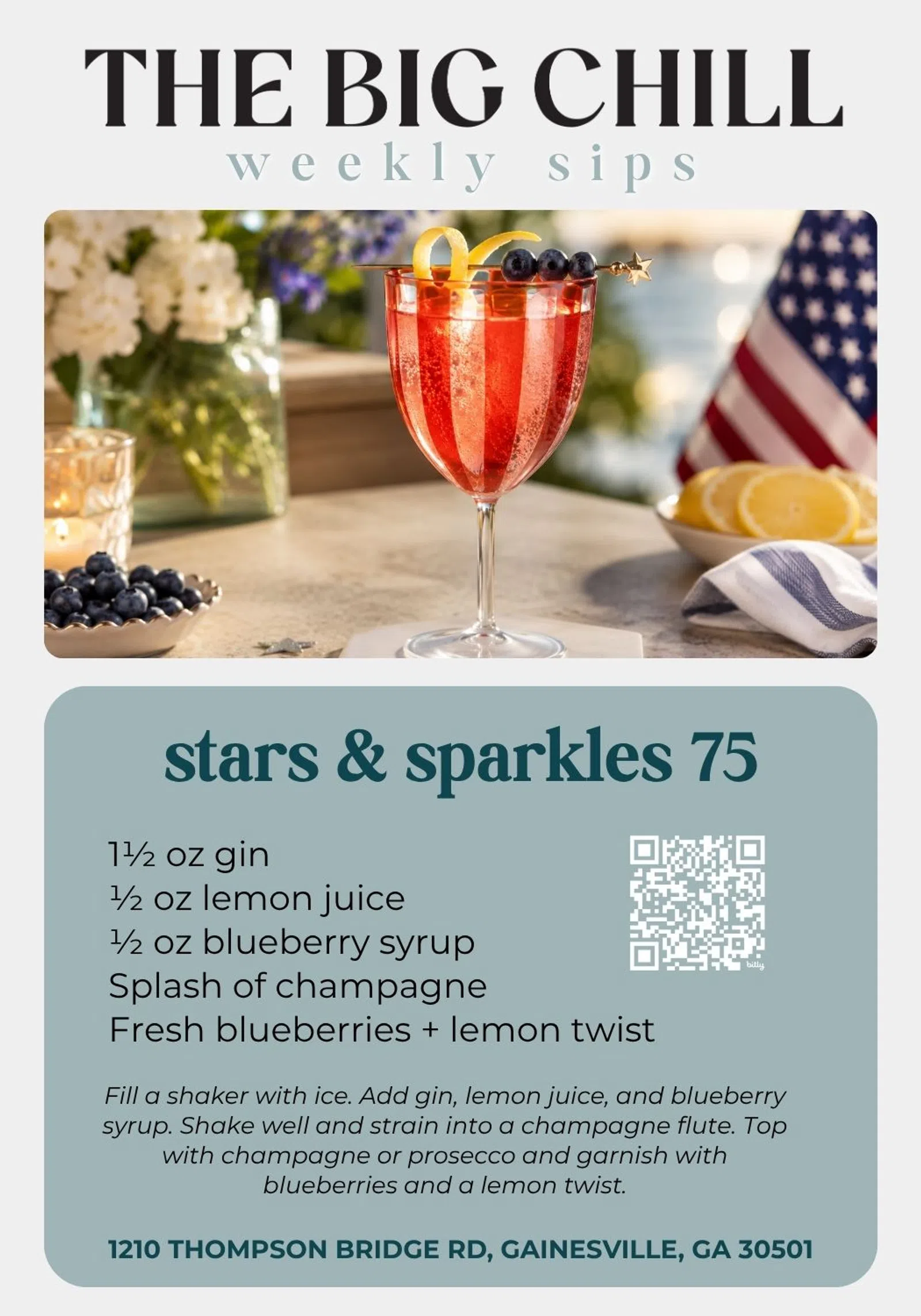 Red gin cocktail with blueberries and lemon twist in a champagne flute on a table with American flag and flowers.