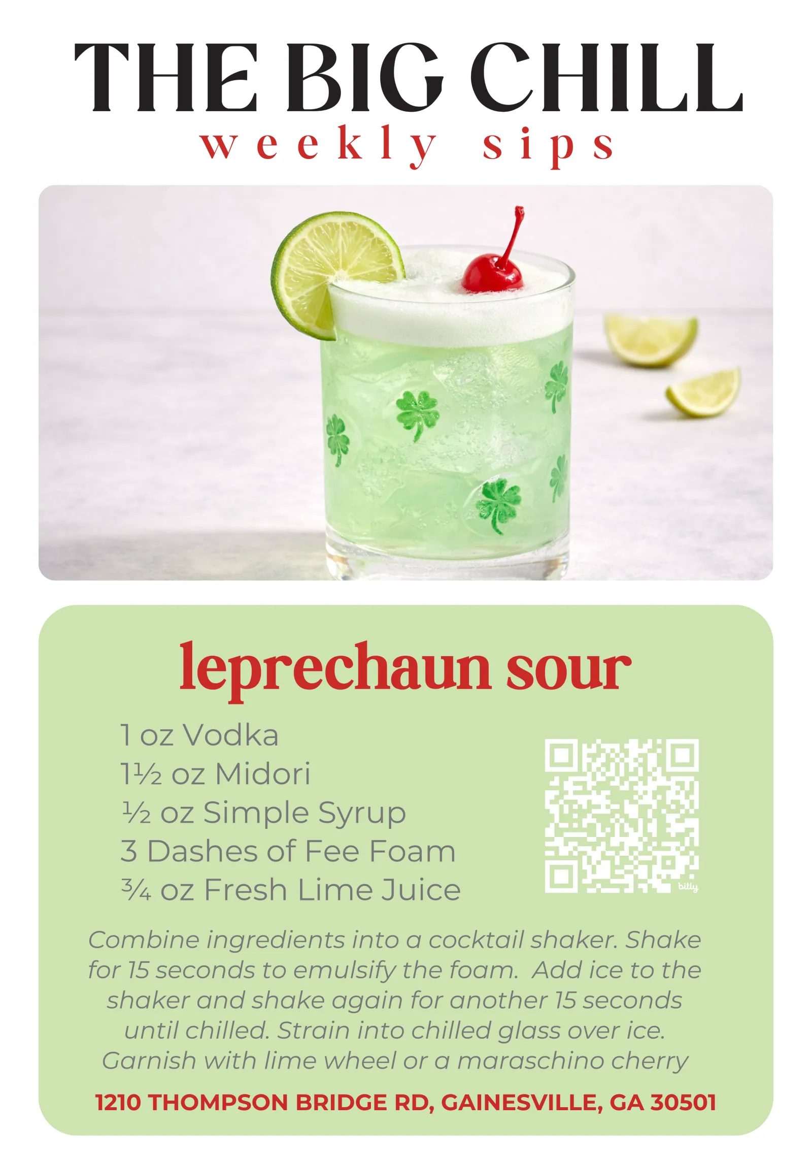 Green Leprechaun Sour cocktail with lime wheel and cherry garnish in clover printed glass on counter.