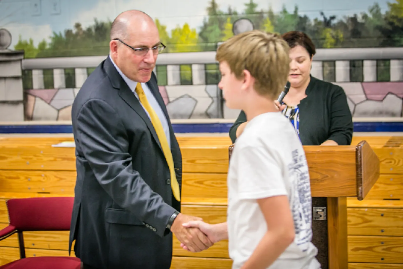 a man and a boy shaking hands