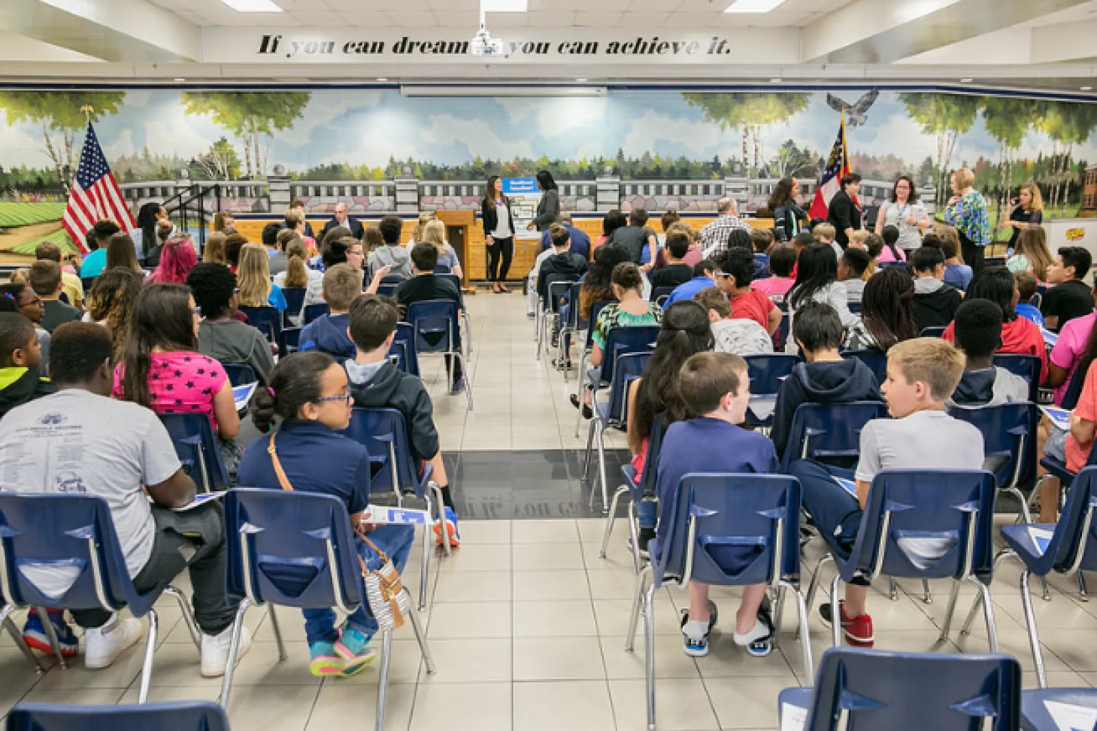 a group of children sitting in chairs