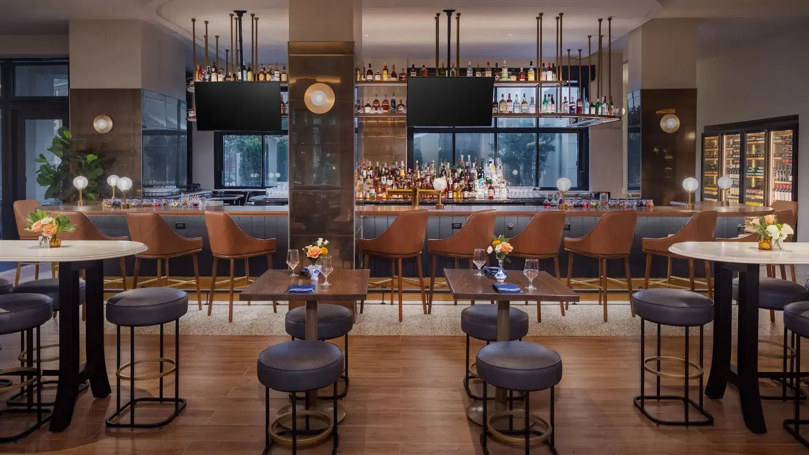 The Lowline by Hyatt JDV Custom Bar Area Millwork with Metal Focal Walls, and Suspended Metal-and-Glass Liquor Shelving