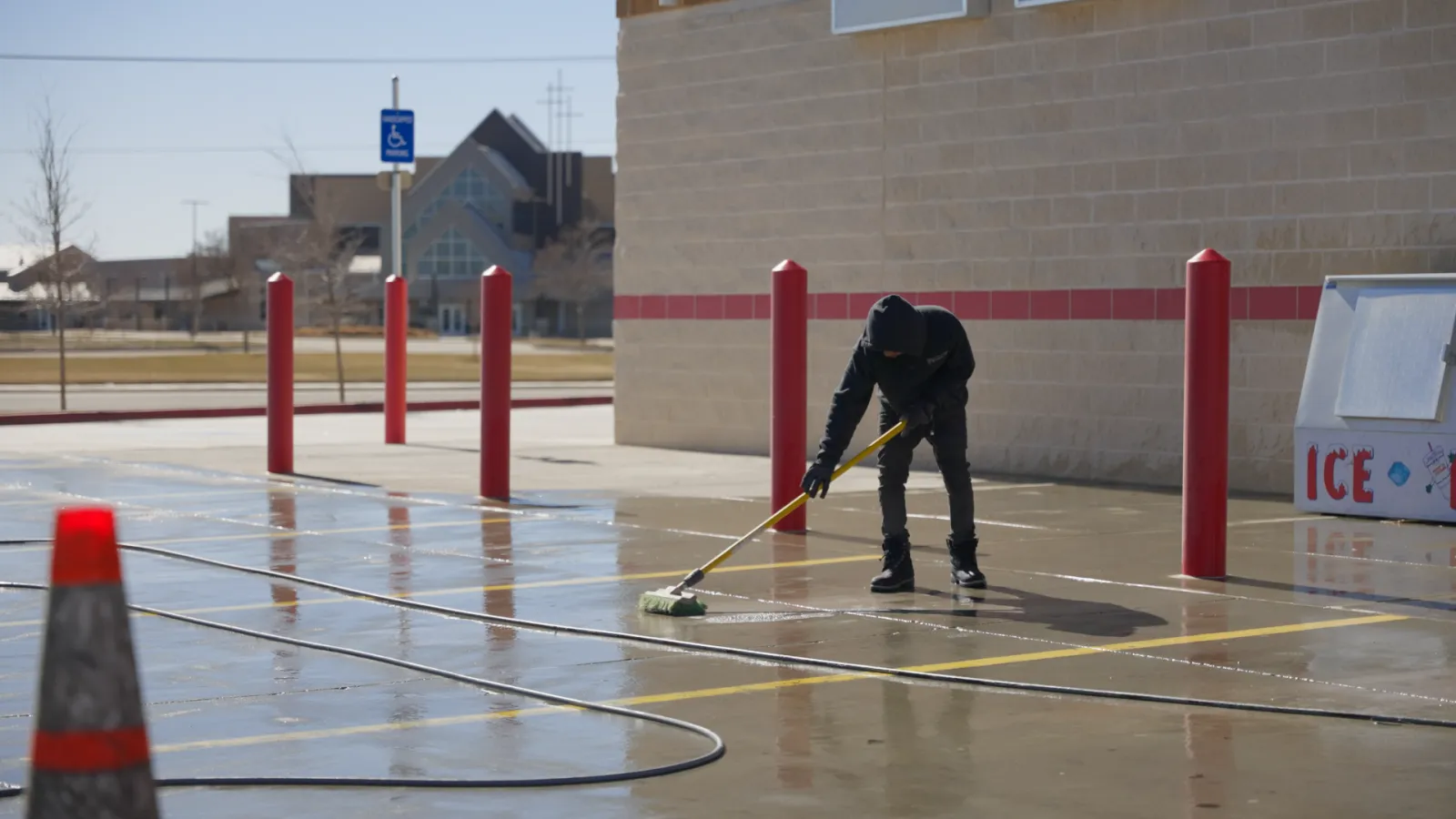 a person cleaning a parking lot