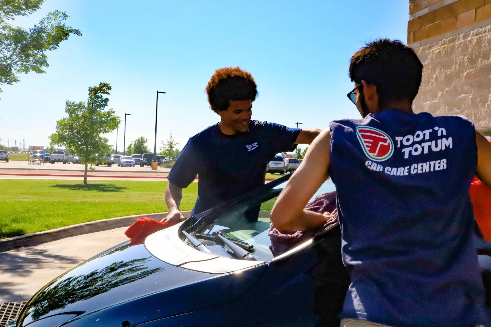 a couple of men working on a car