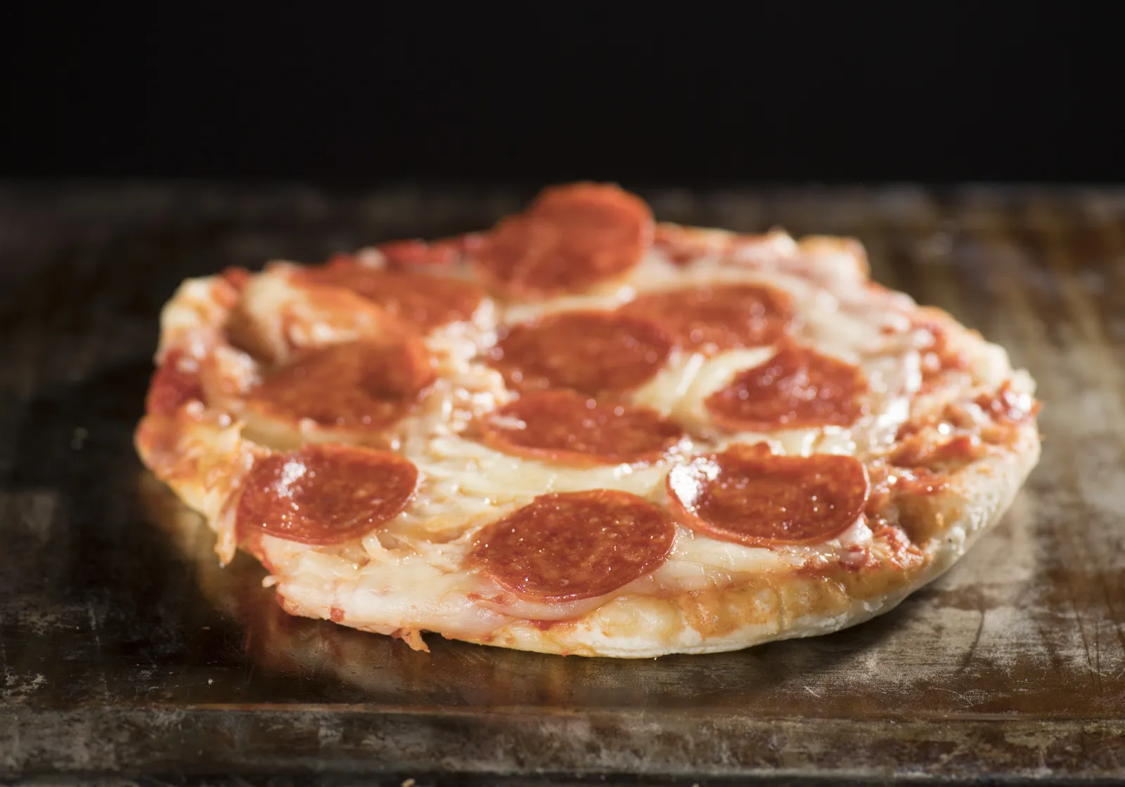 a pepperoni pizza on a table