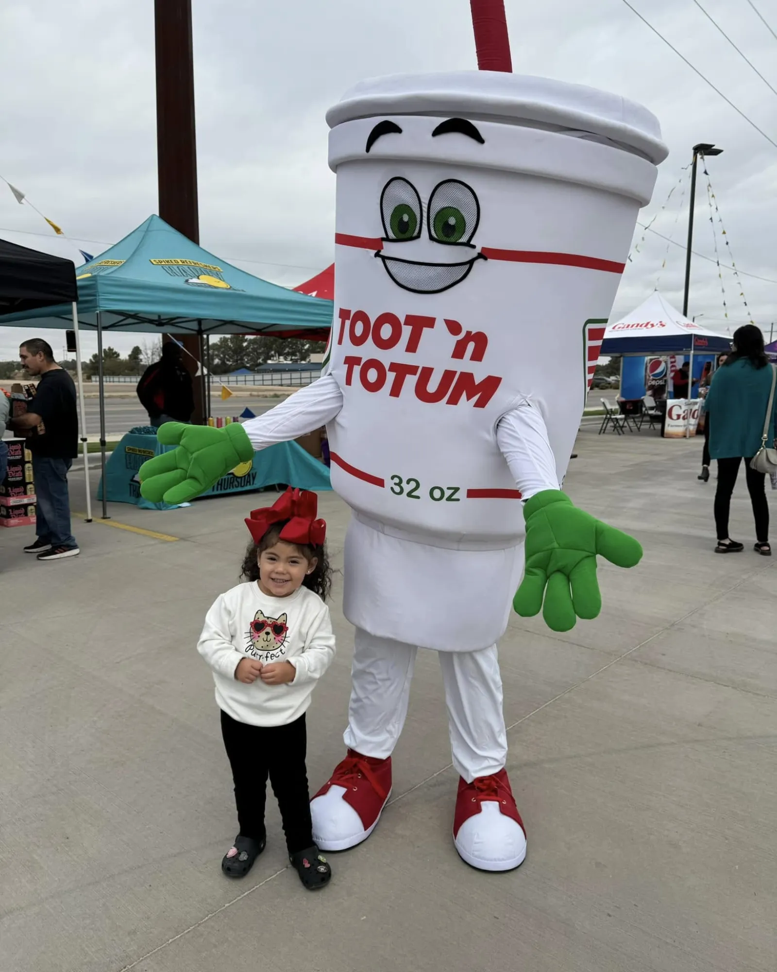 a girl posing with a person in a garment