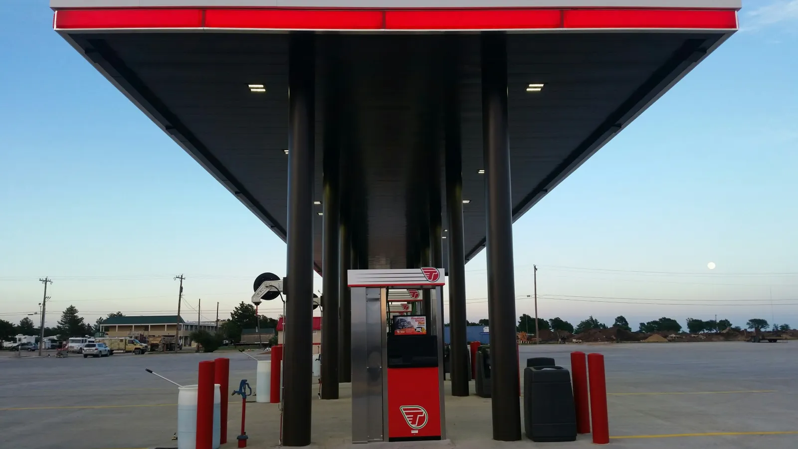 a gas station with a red awning