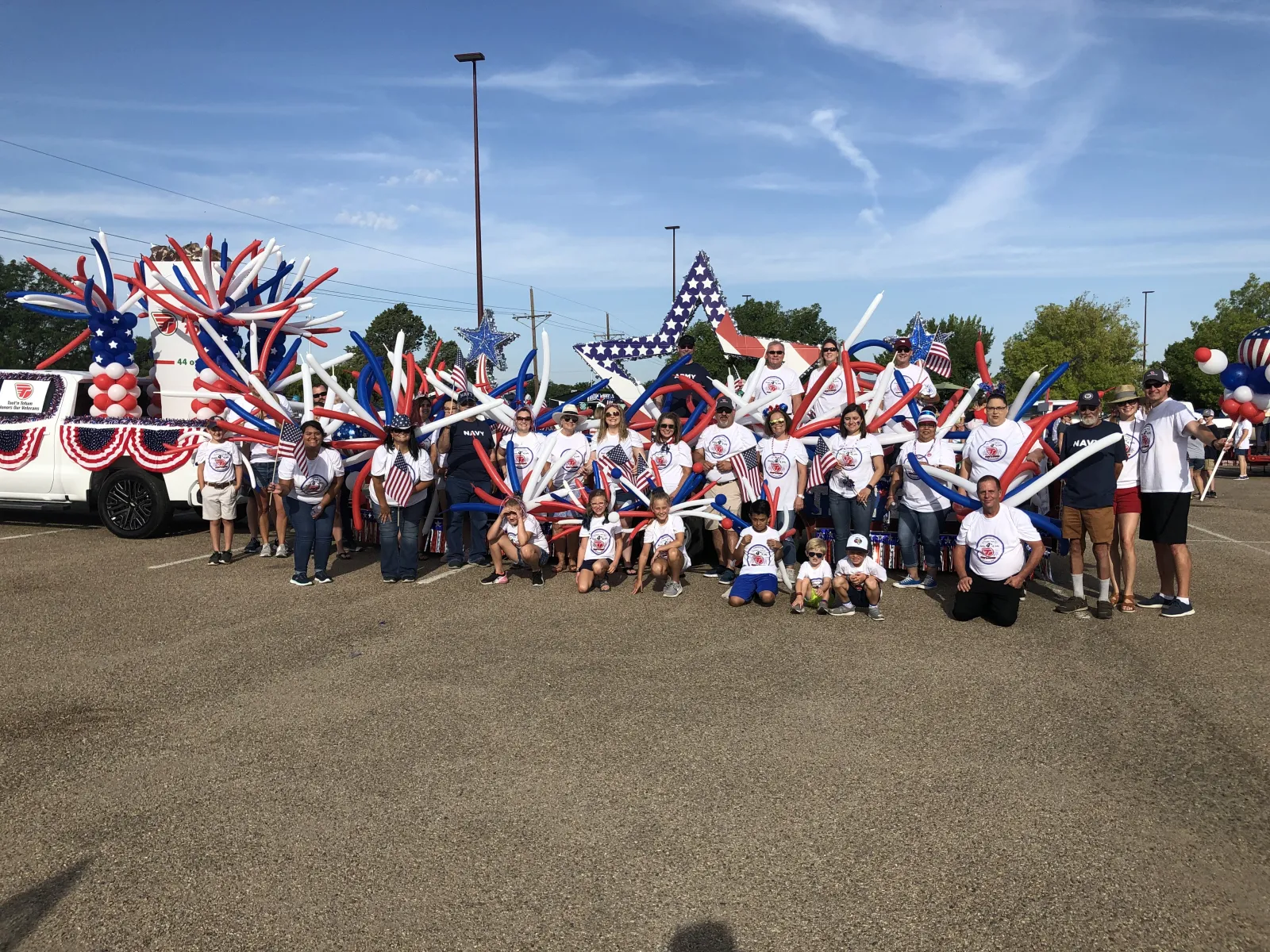 a group of people holding flags with Cadillac Ranch in the background