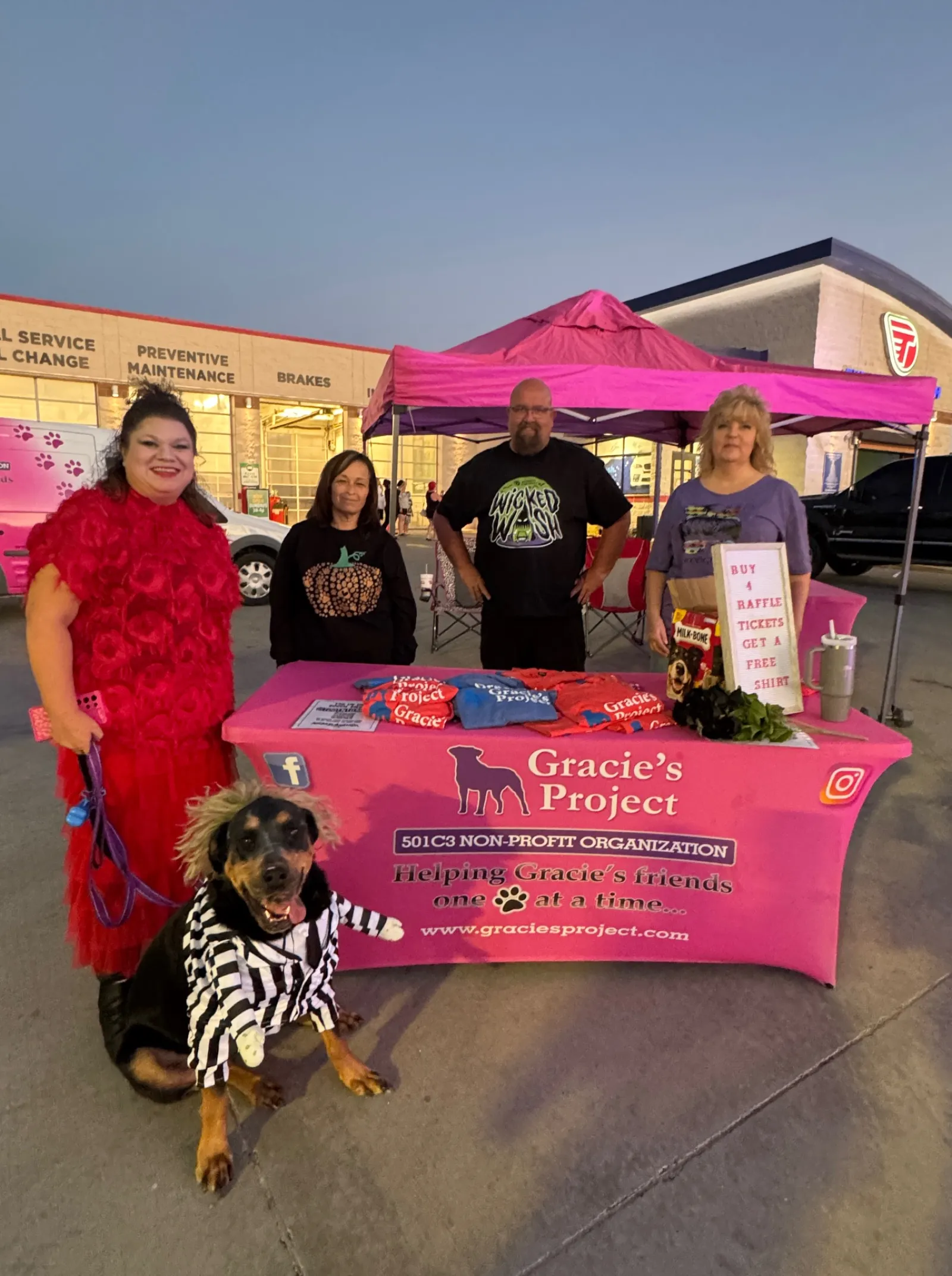 a group of people standing outside a food stand