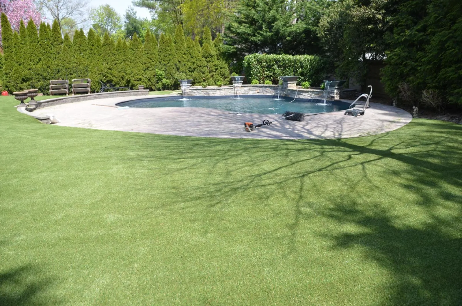 a pool with a green lawn