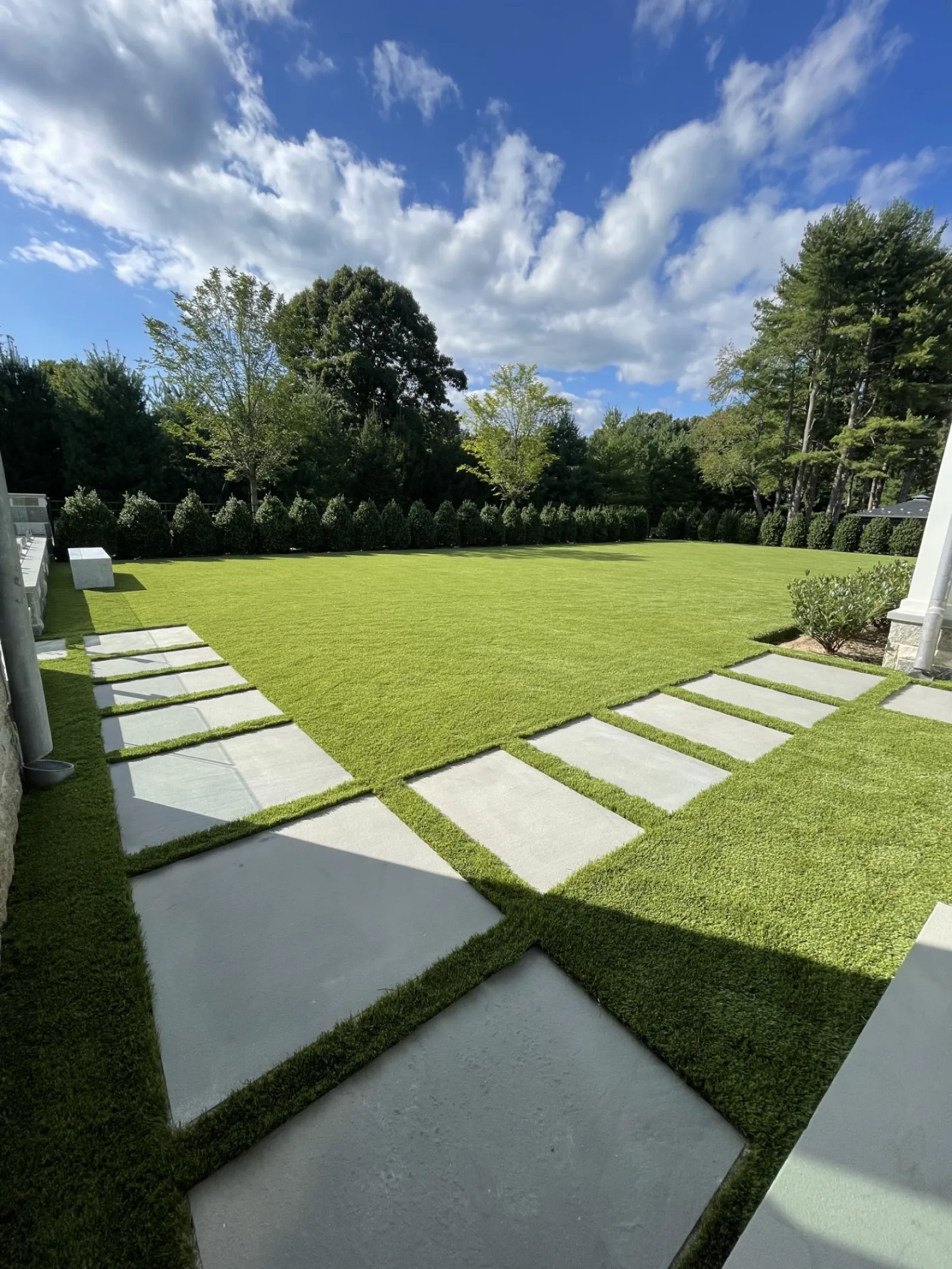 a large green lawn with white stones