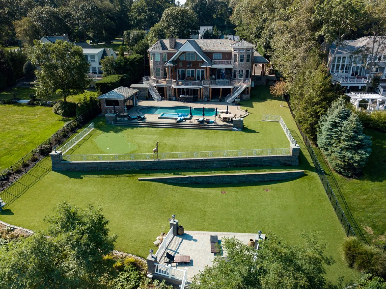 a large house with a pool in the front
