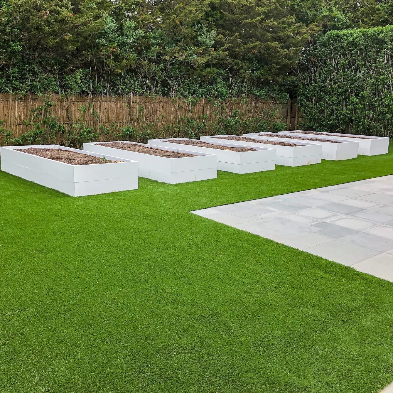 a large green lawn with white boxes