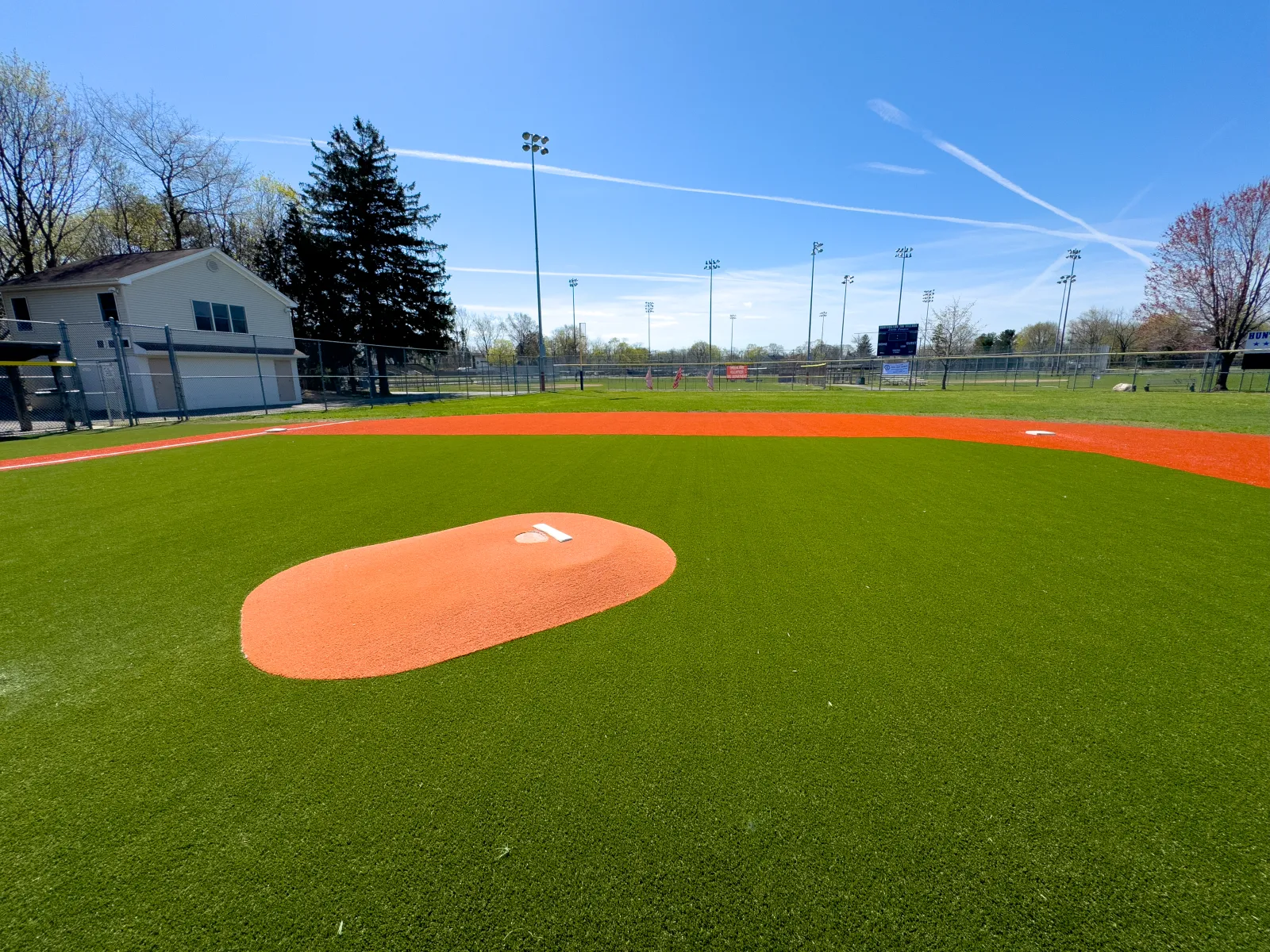 a baseball field with a red and white ball in the middle