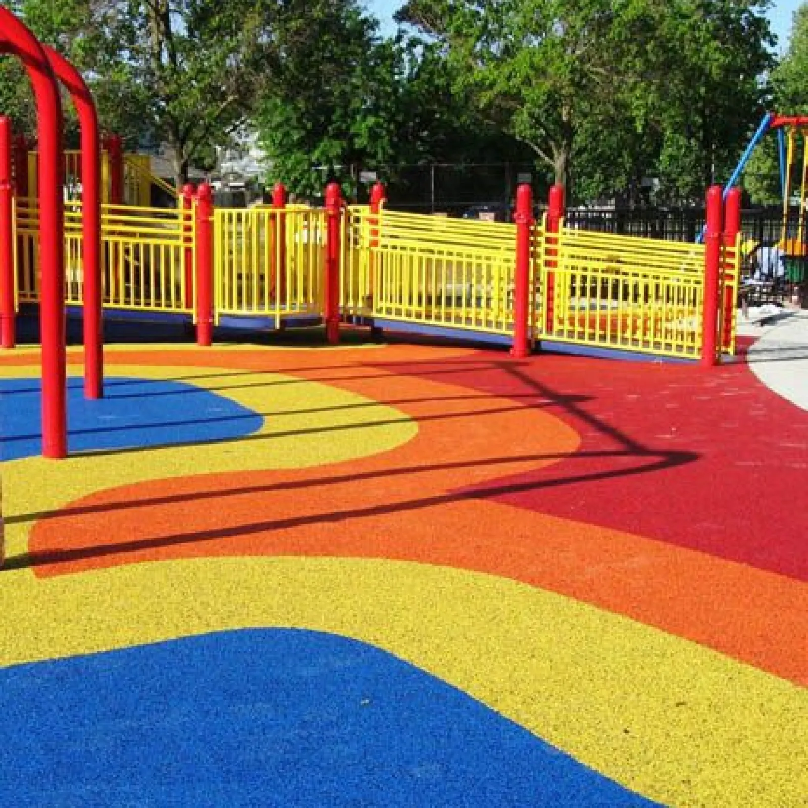 a playground with red and yellow poles