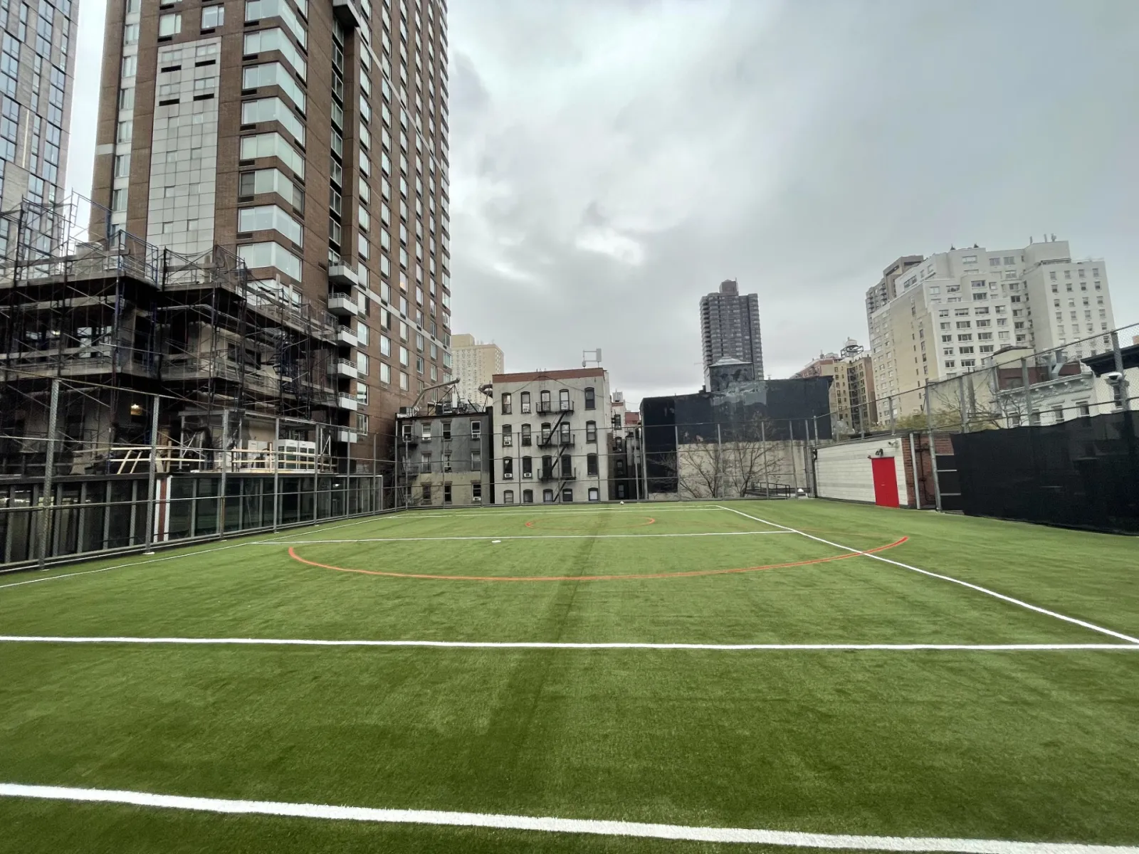 a football field with buildings in the background