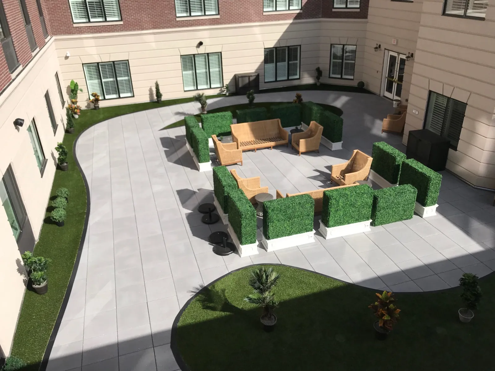 a courtyard with a pool and chairs