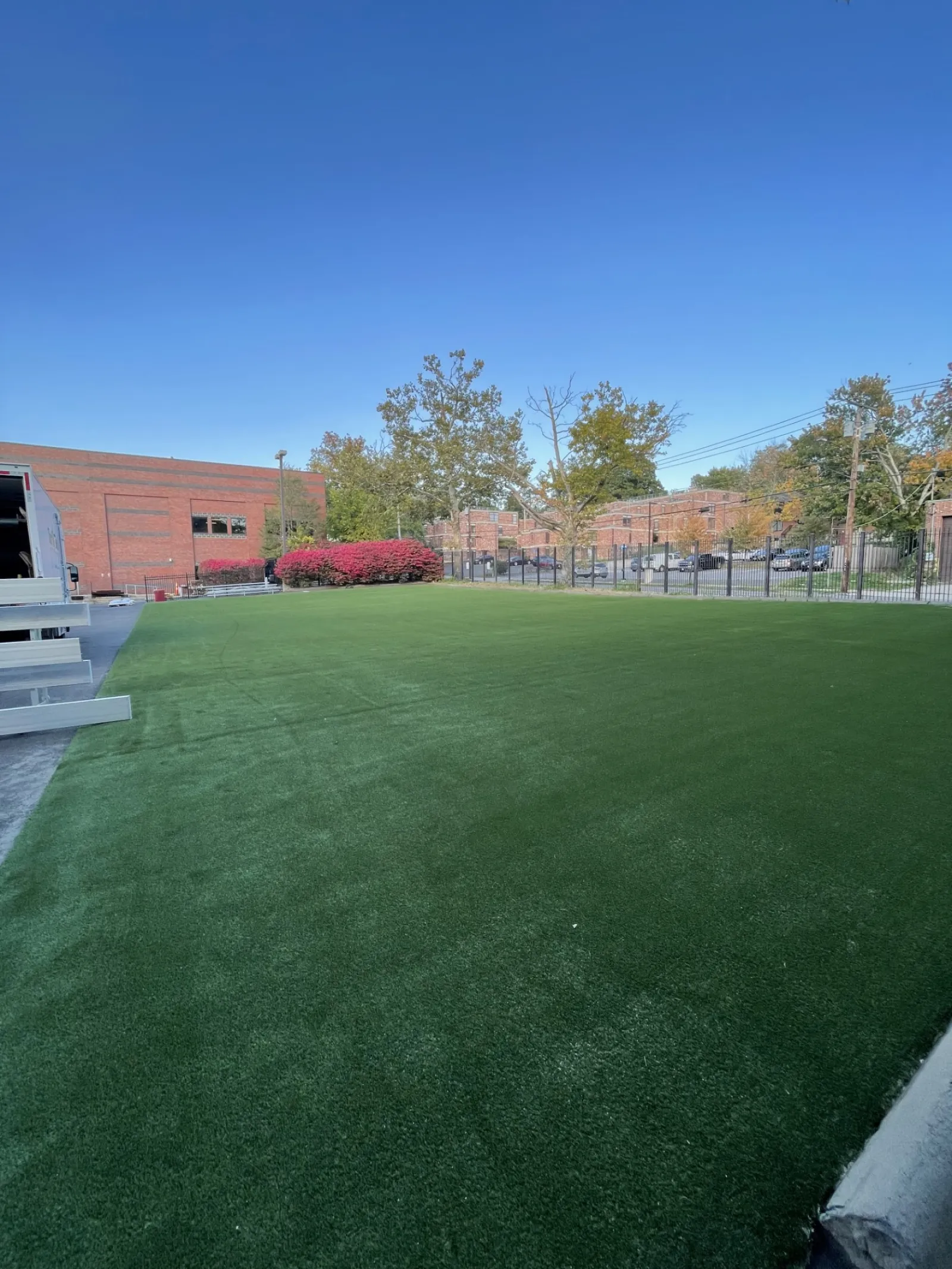 a green lawn with a building in the background