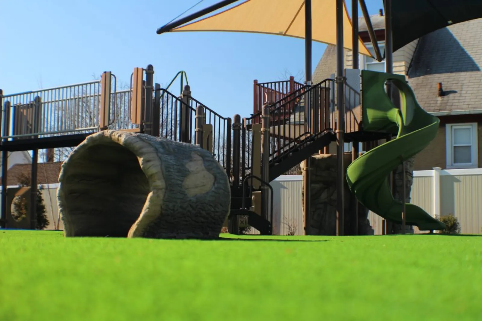a large green slide in a yard