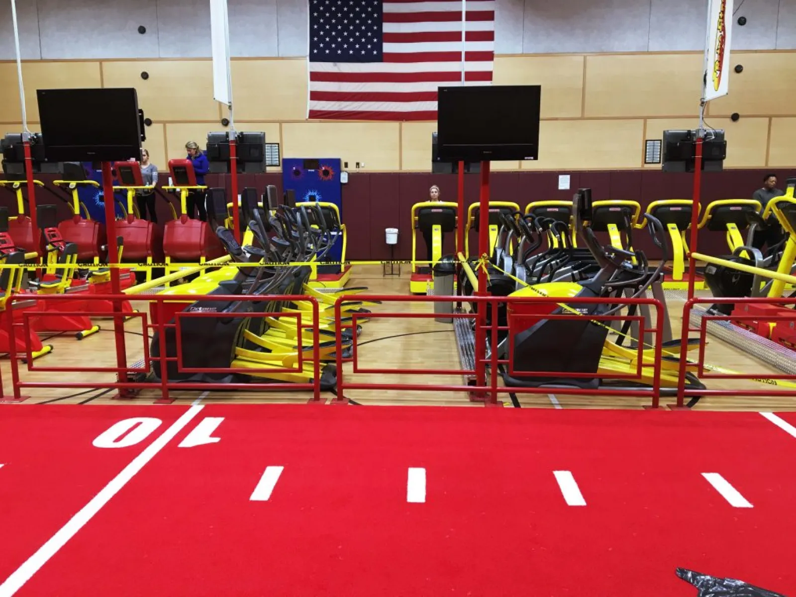 a gym with red and yellow seats