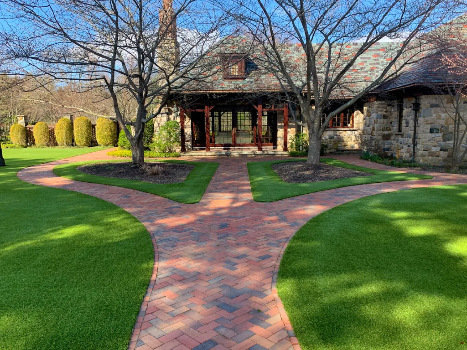 a brick driveway leading to a house