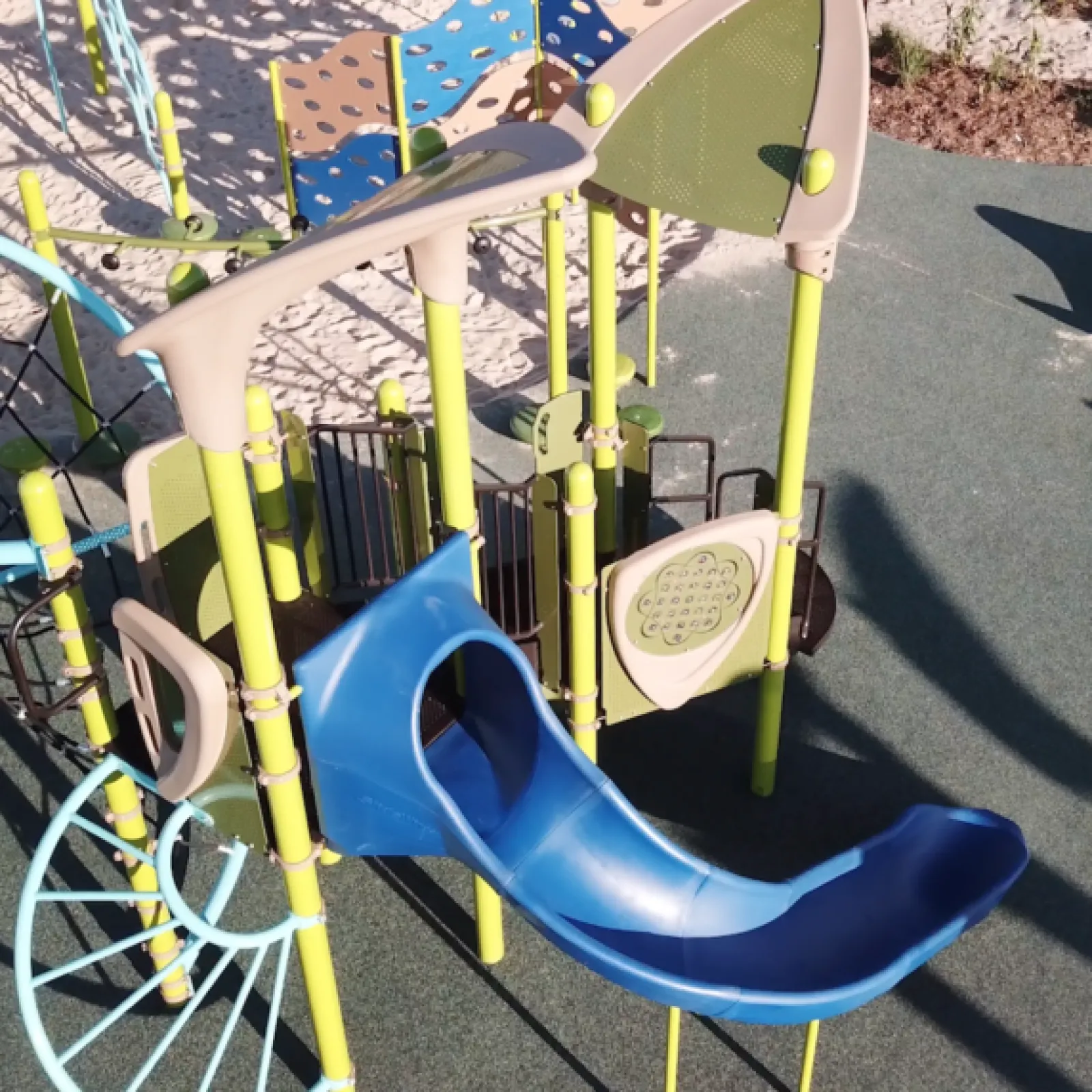 a playground with yellow and blue playground equipment
