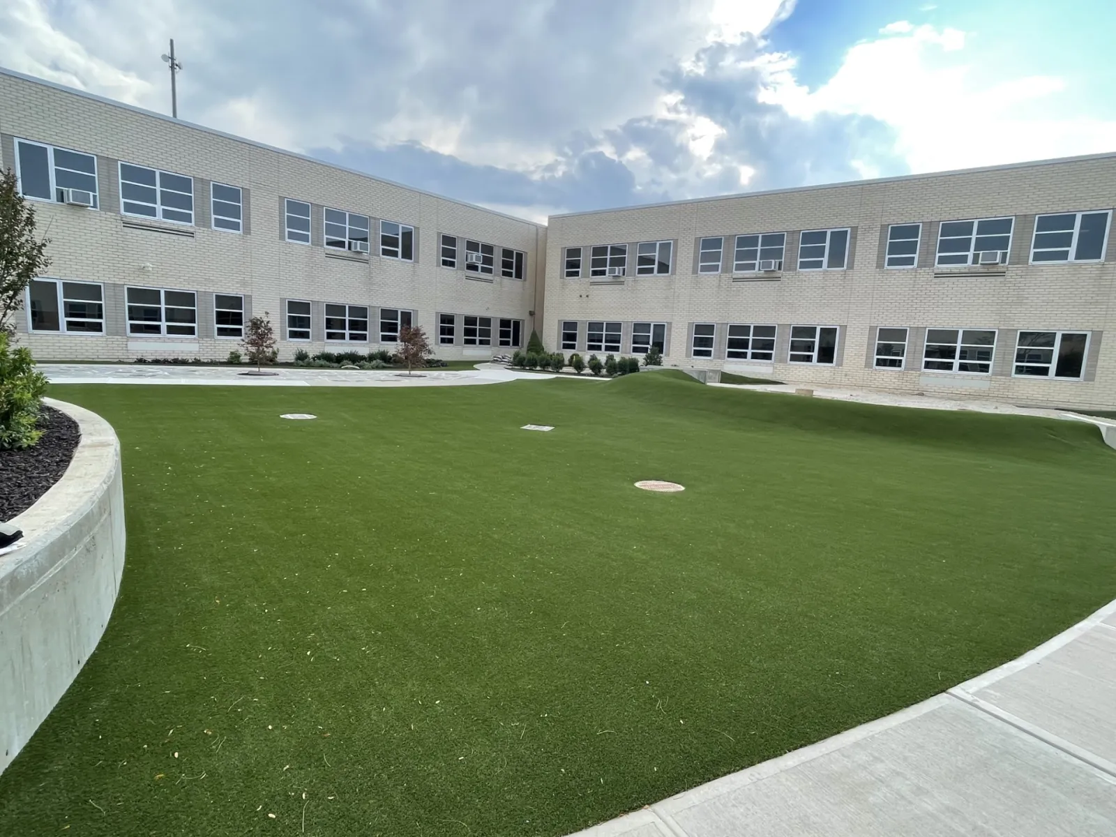 a building with a green lawn