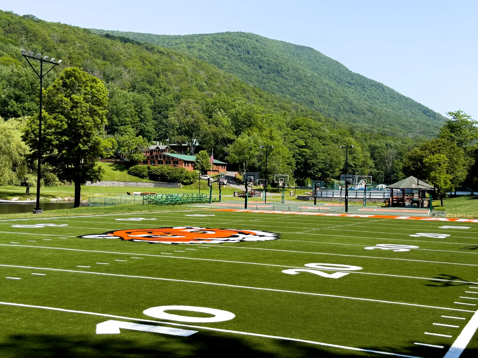 a football field with a hill in the background