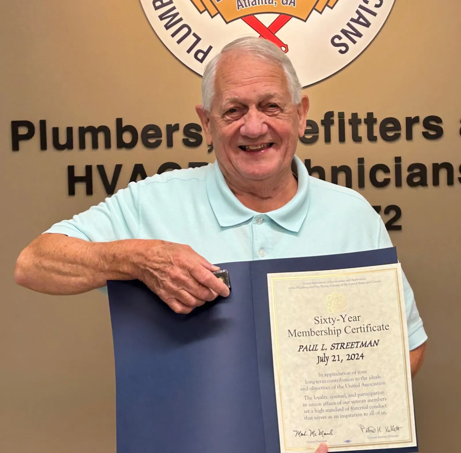 a man holding a certificate