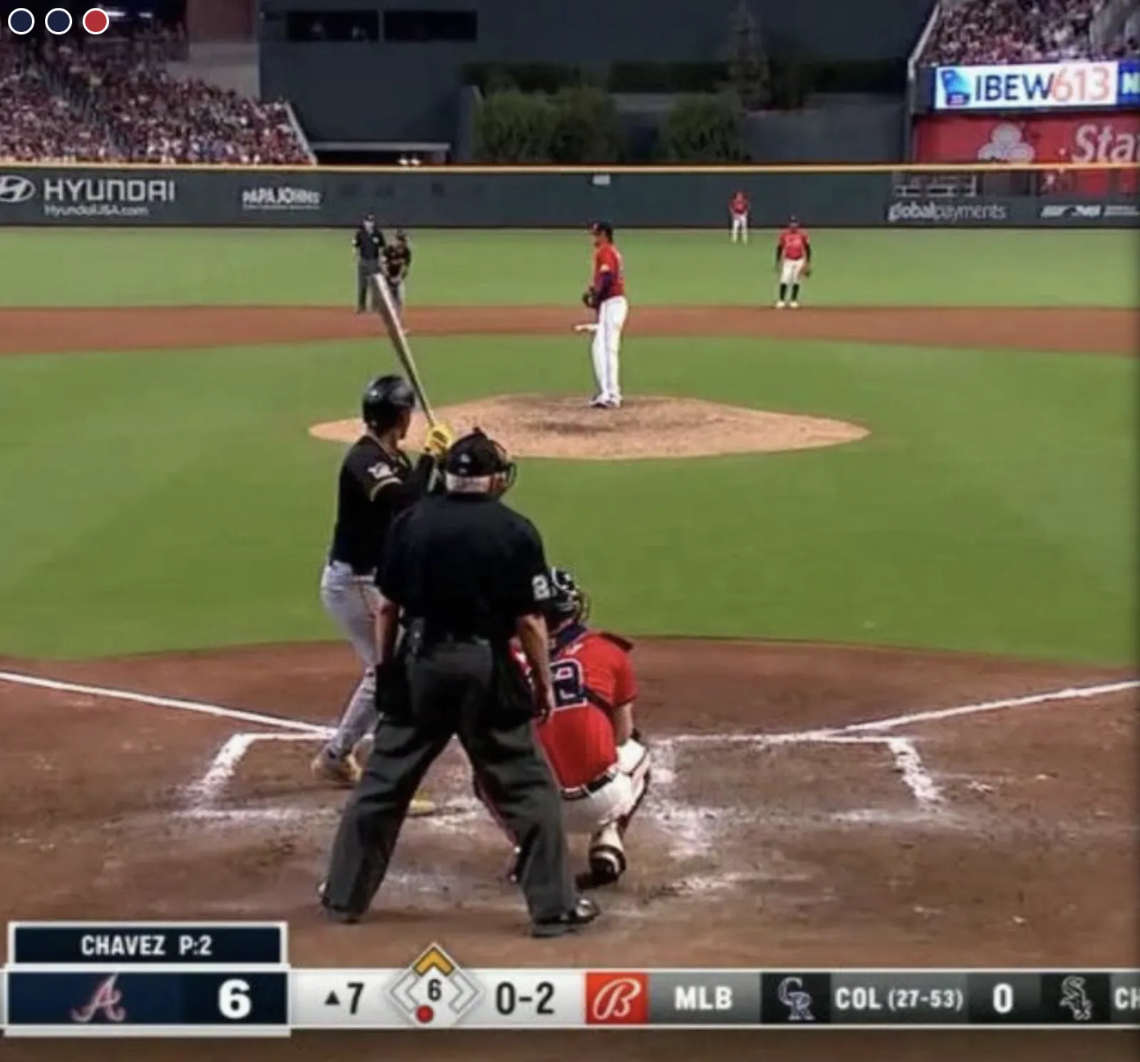 a baseball player prepares to swing a bat