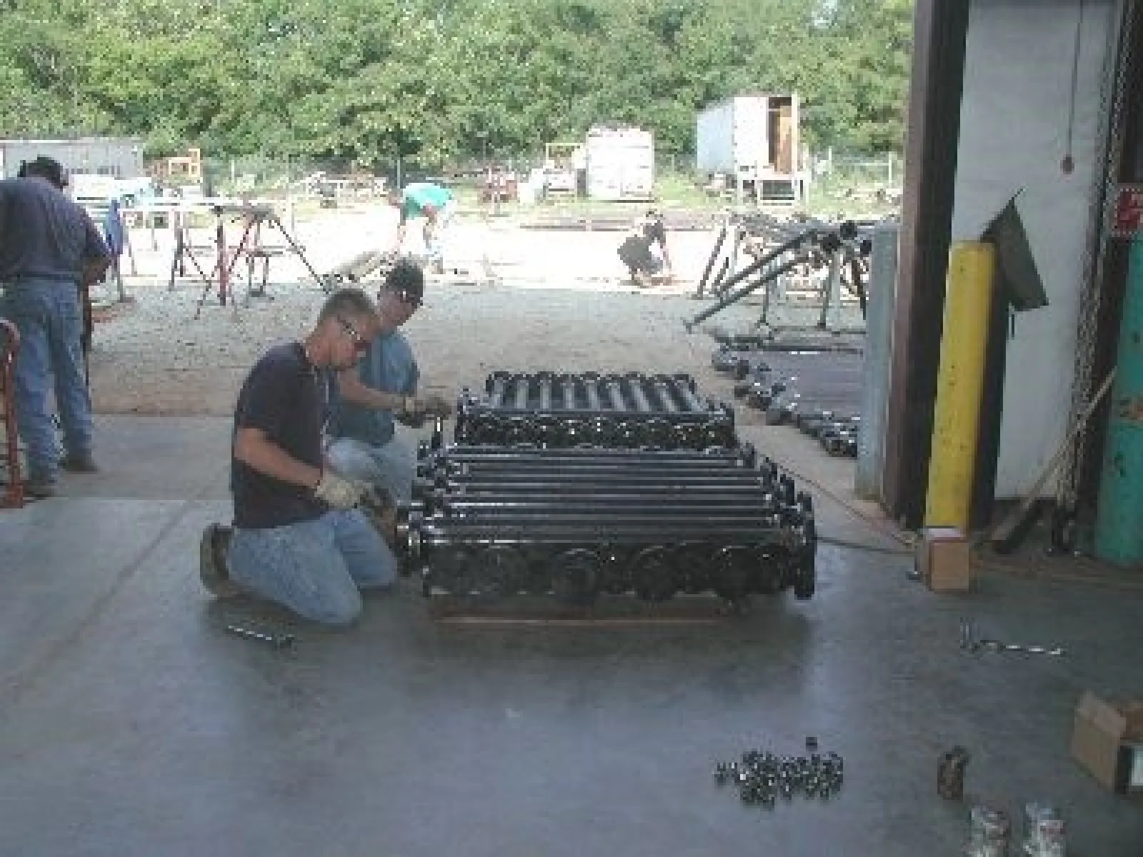 a group of men working on a machine