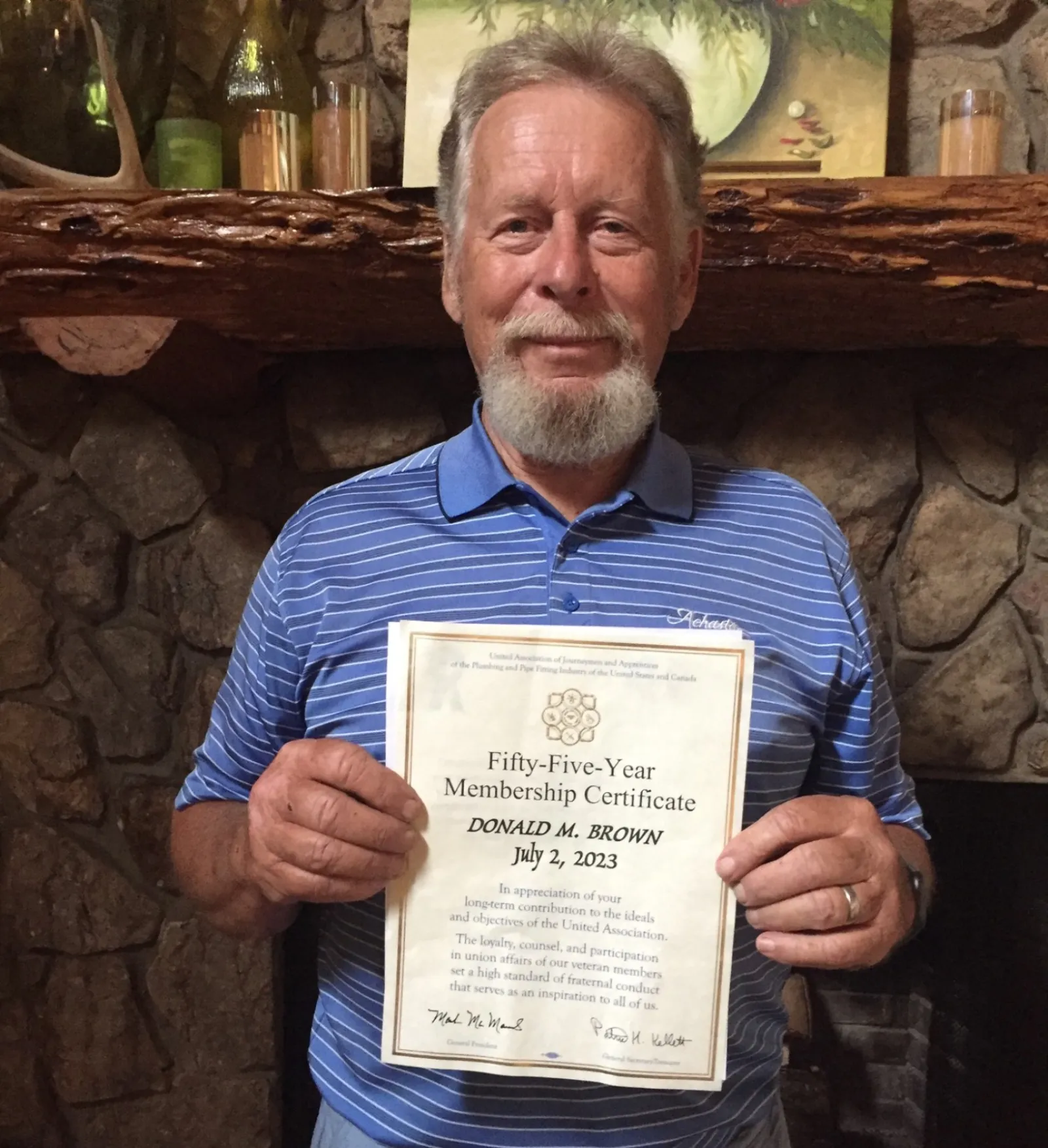 a man holding a certificate