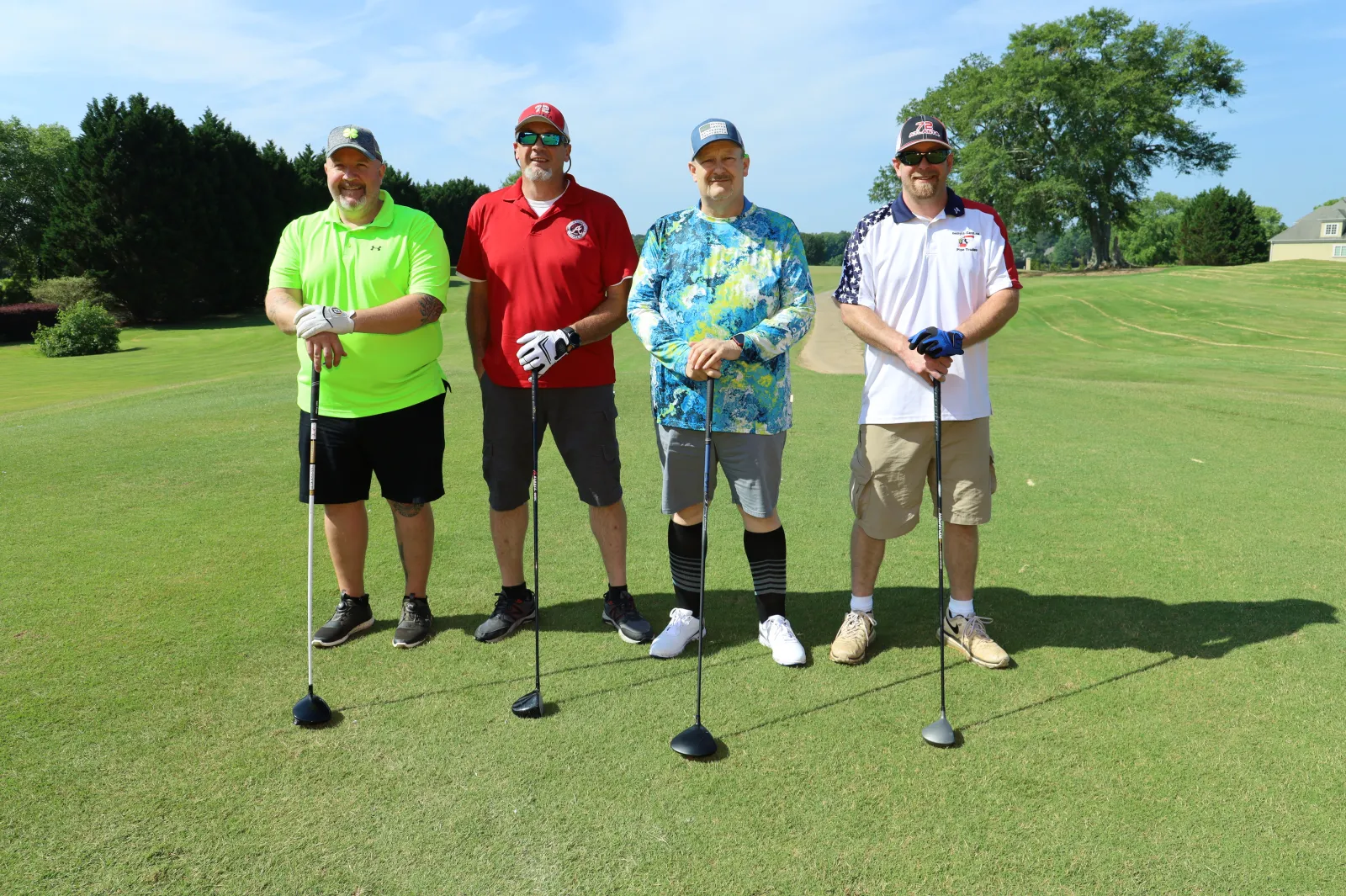 a group of people posing for a photo on a golf course