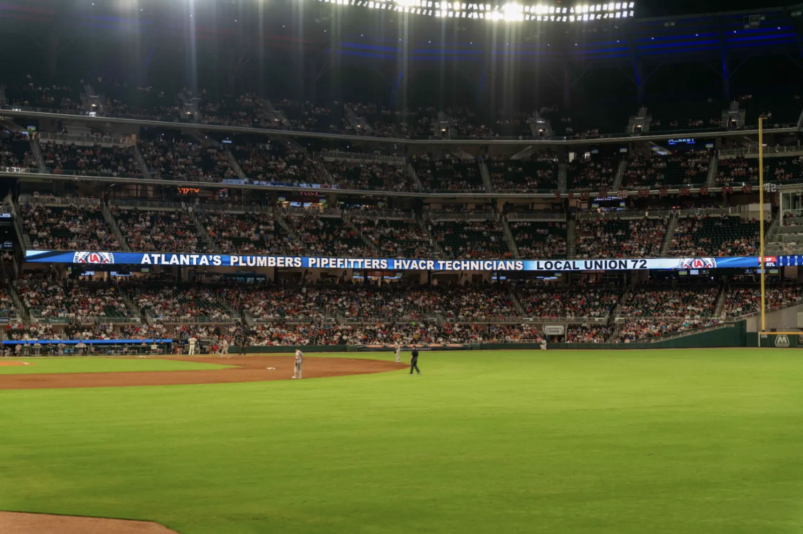 a baseball field with a crowd watching