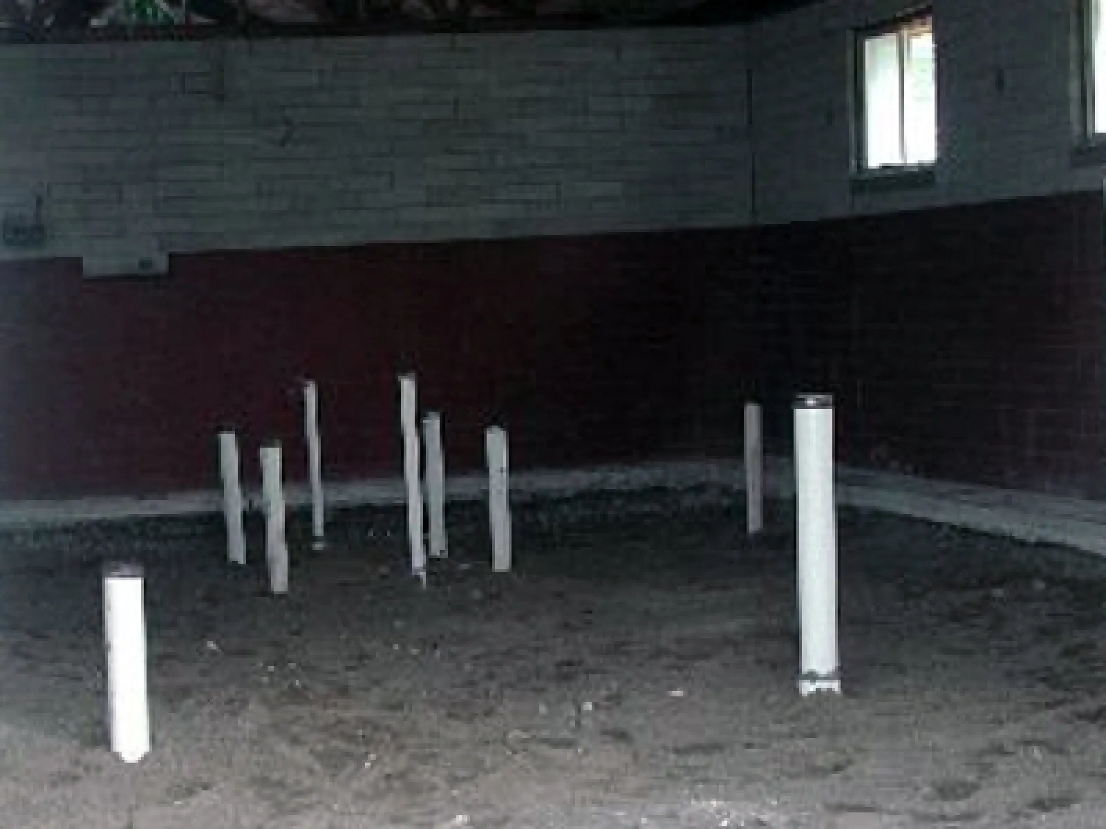 a row of white poles in front of a building