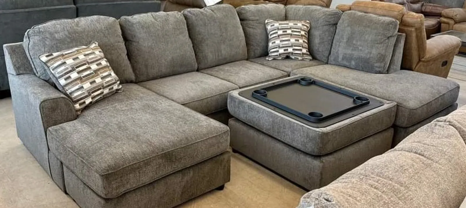 a couch with a game console and pillows