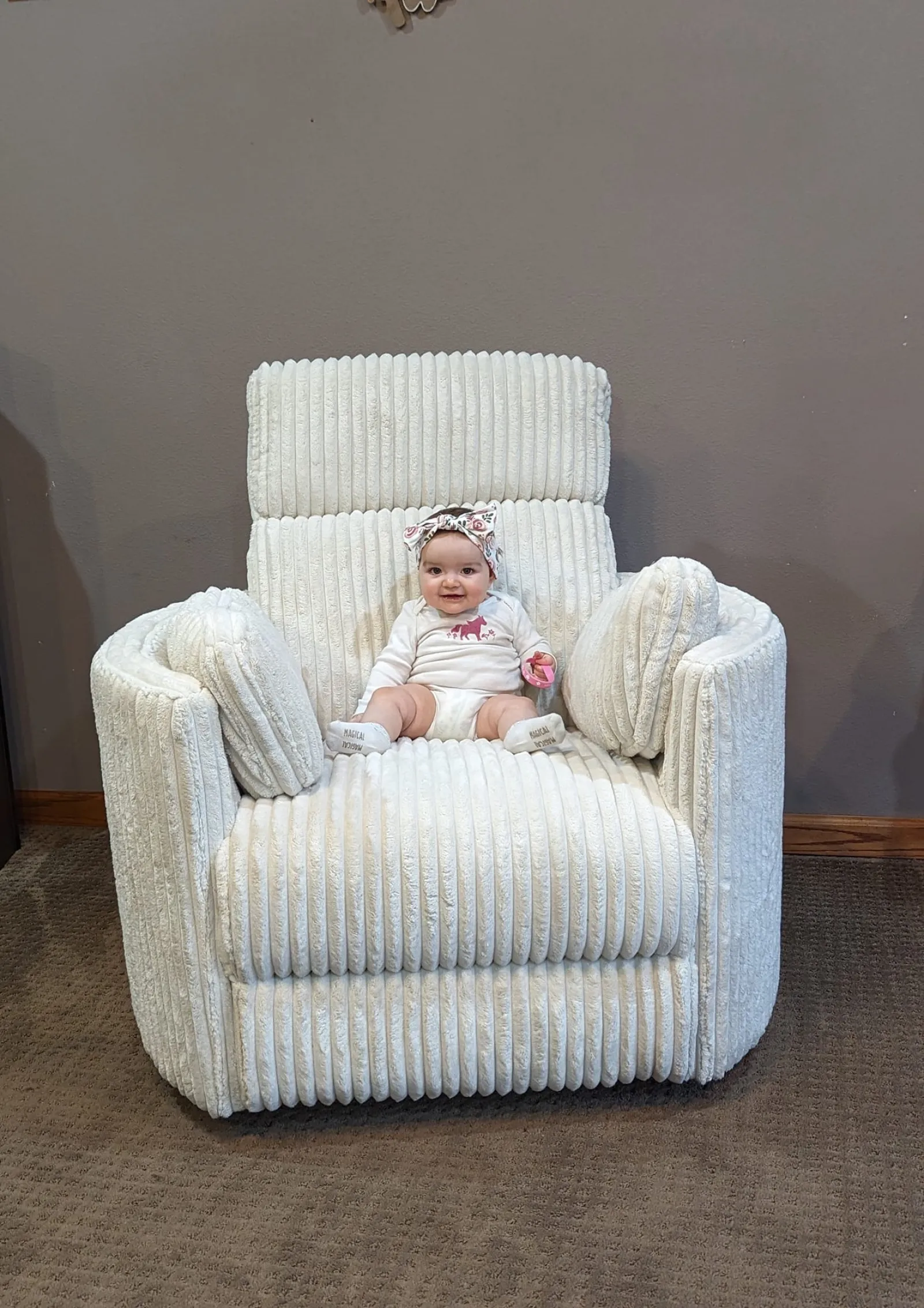 a baby sitting in a chair