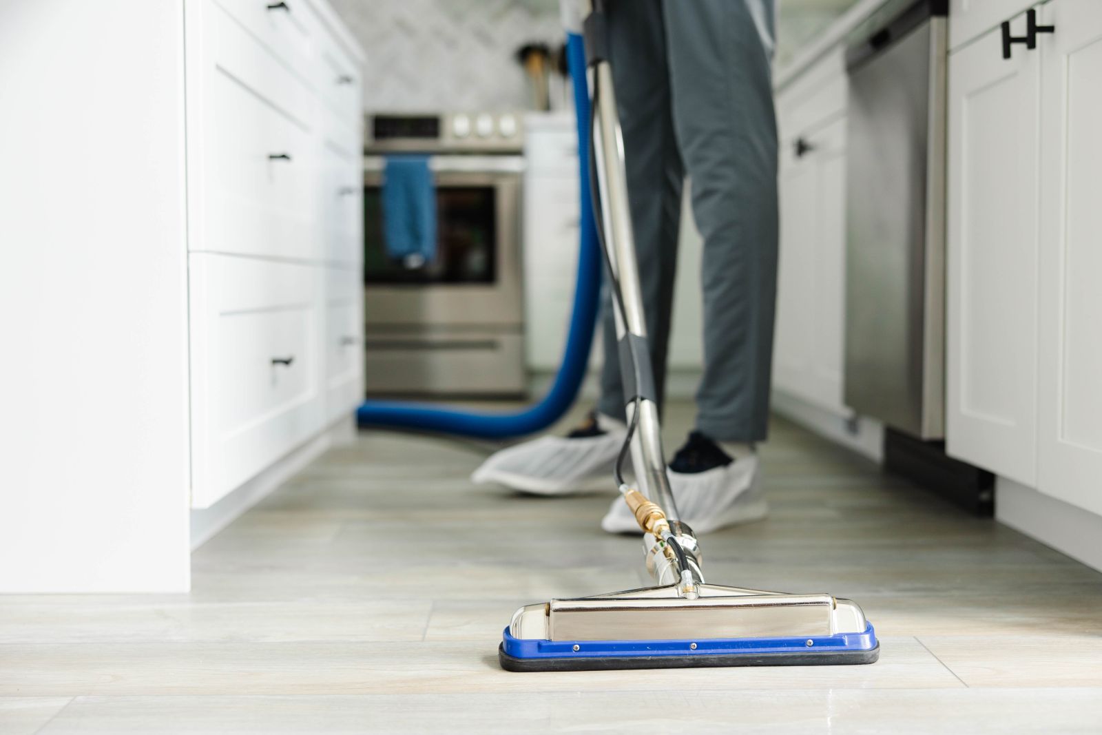 Shiny clean hardwood floor in a kitchen after its been cleaned, mopped, and sealed by a Zerorez Professional