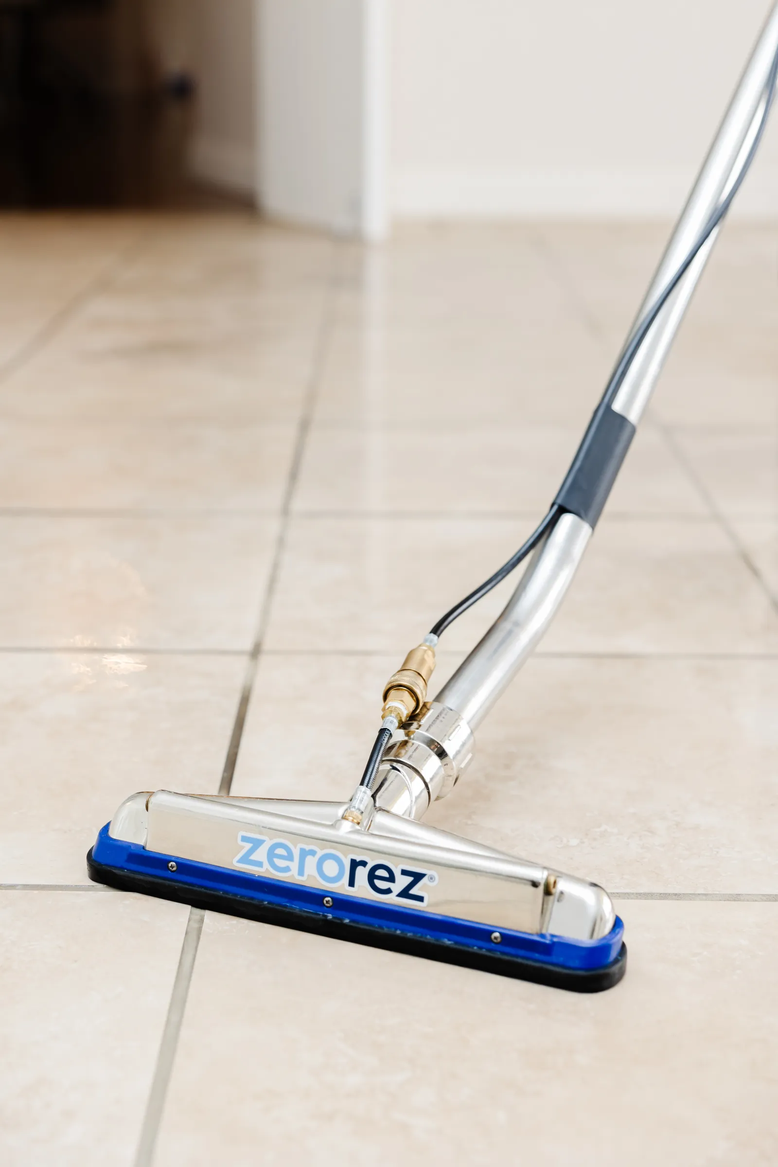 Close up of a Zerorez® tile cleaning tool on beige tile floor