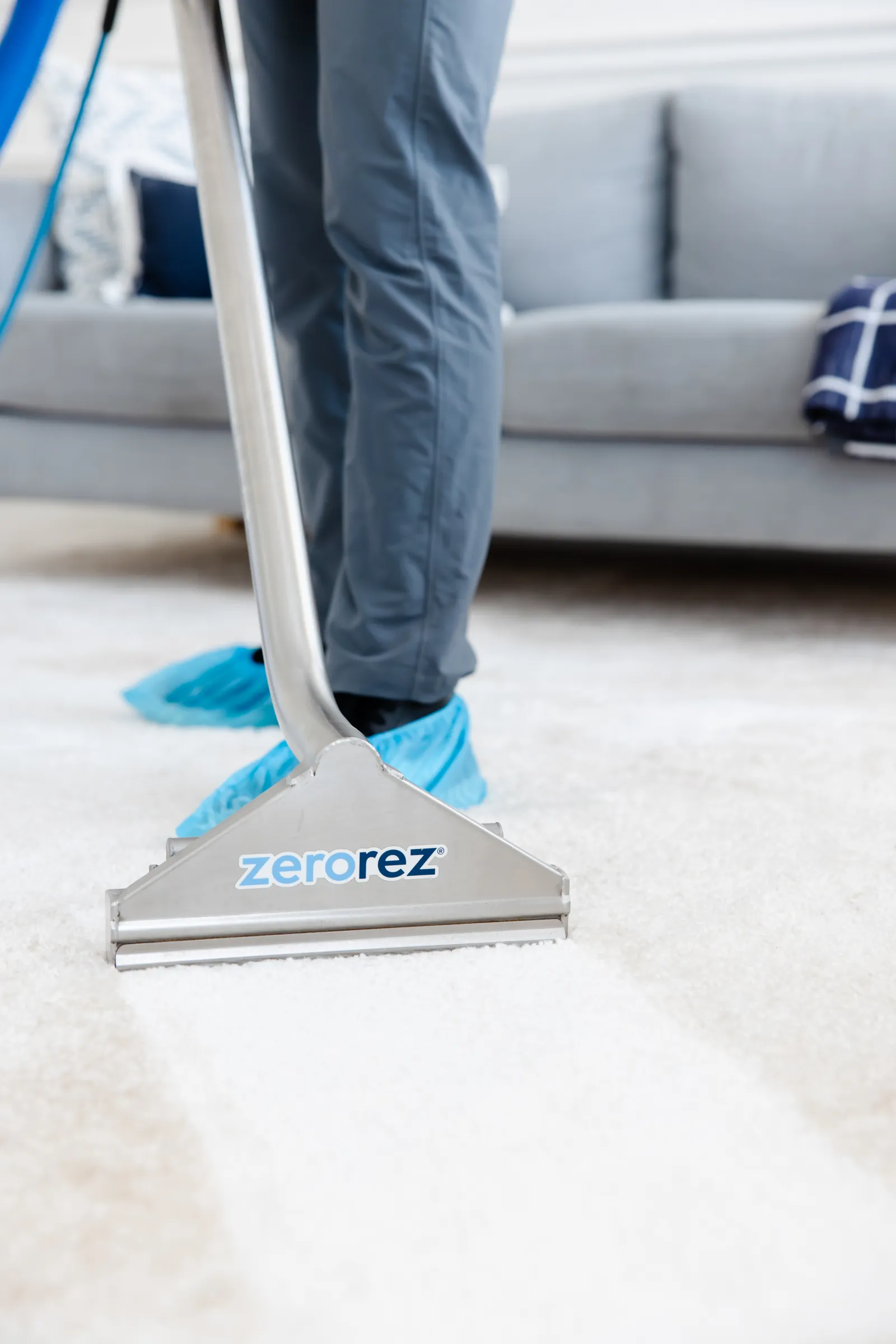close up of a white carpet being cleaned by a Zerorez Zr Wand after it was pretreated, before steam cleaning with hot water extraction