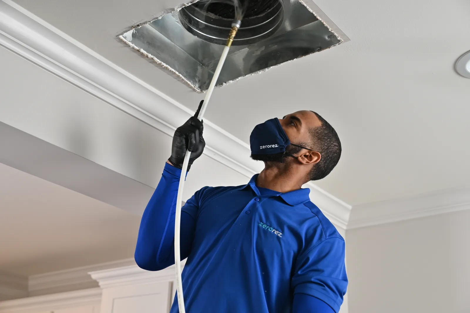 Zerorez® air duct technician cleaning out an HVAC system air dust register
