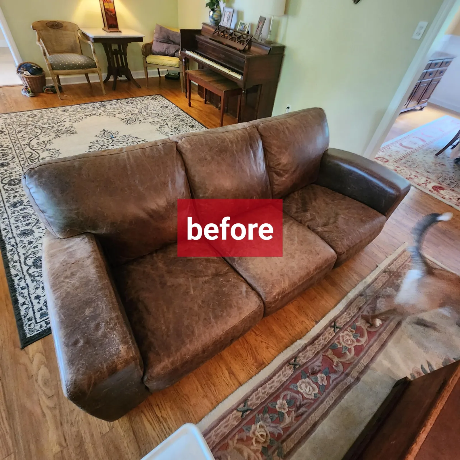 a worn leather couch before professional leather couch cleaning services from Zerorez, in a real customer's home
