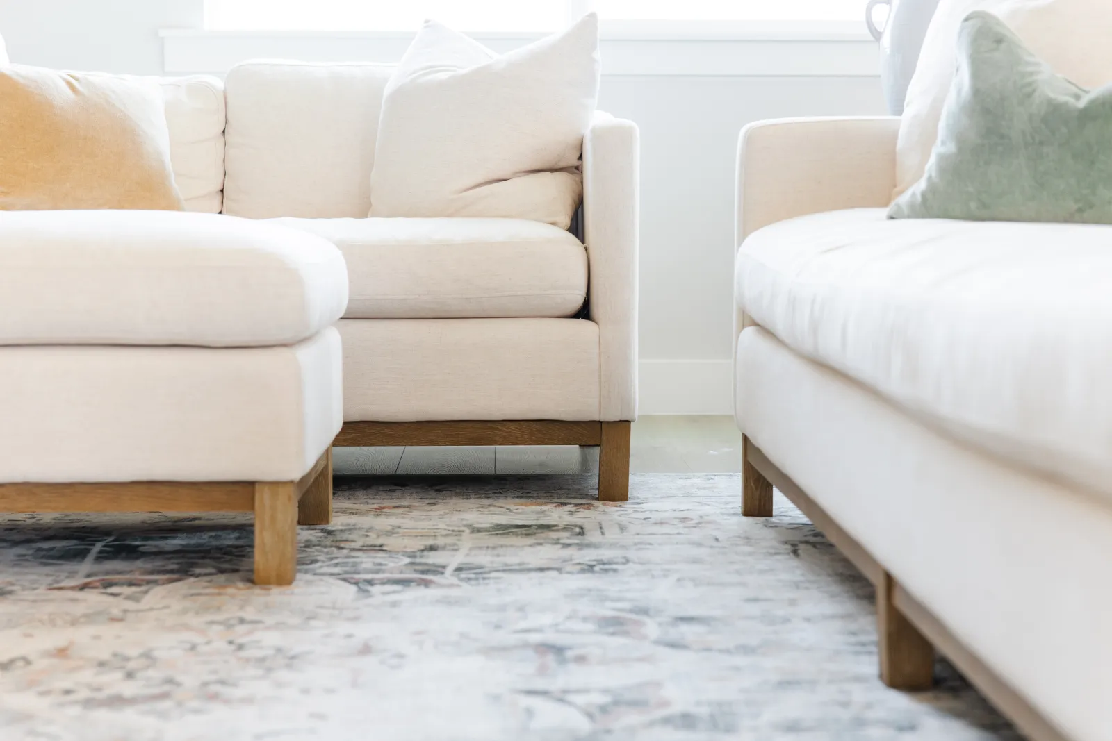 cream couch with gray and off white area rug