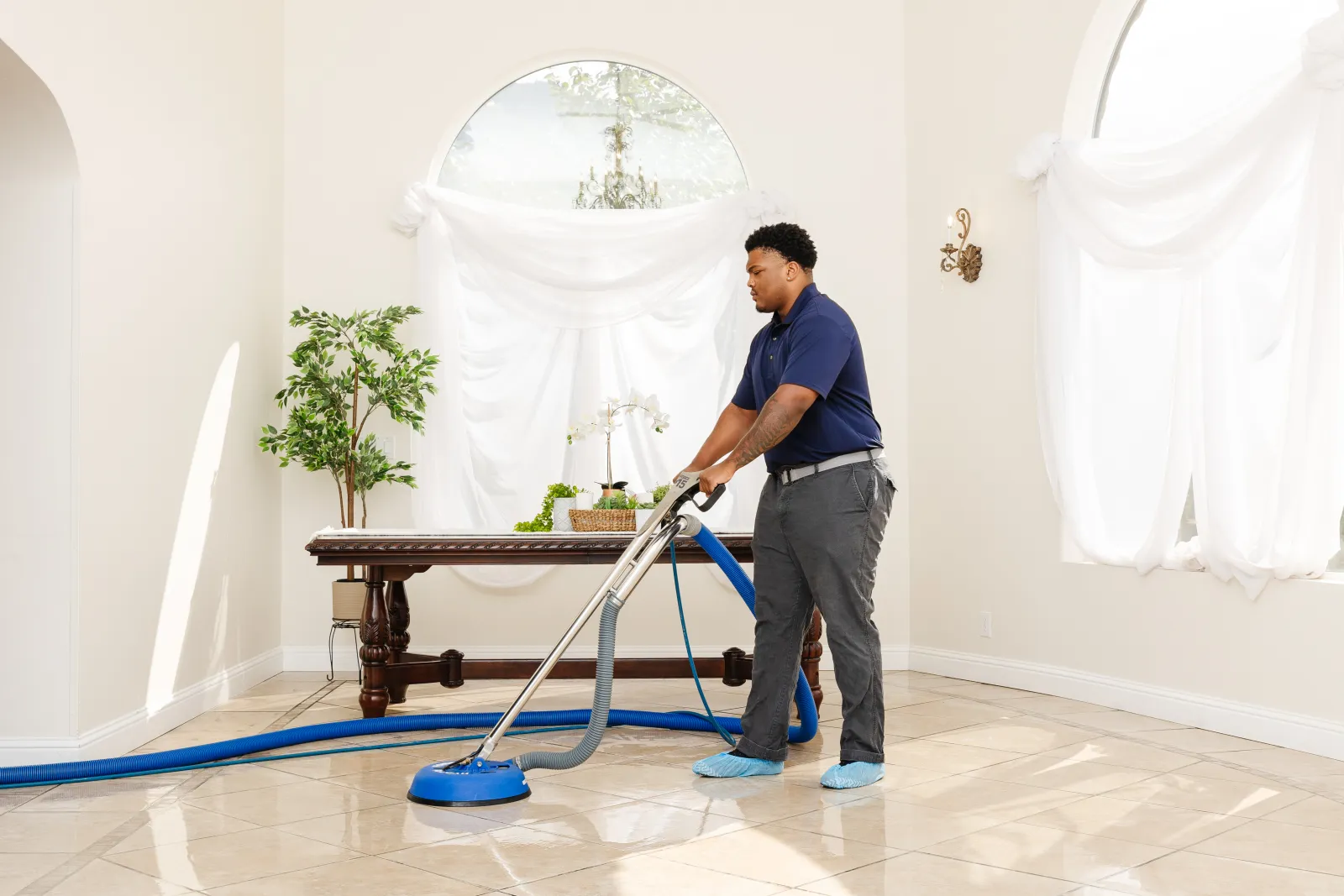 male zerorez technician cleaning tile in a dining room setting to help it not be slippery